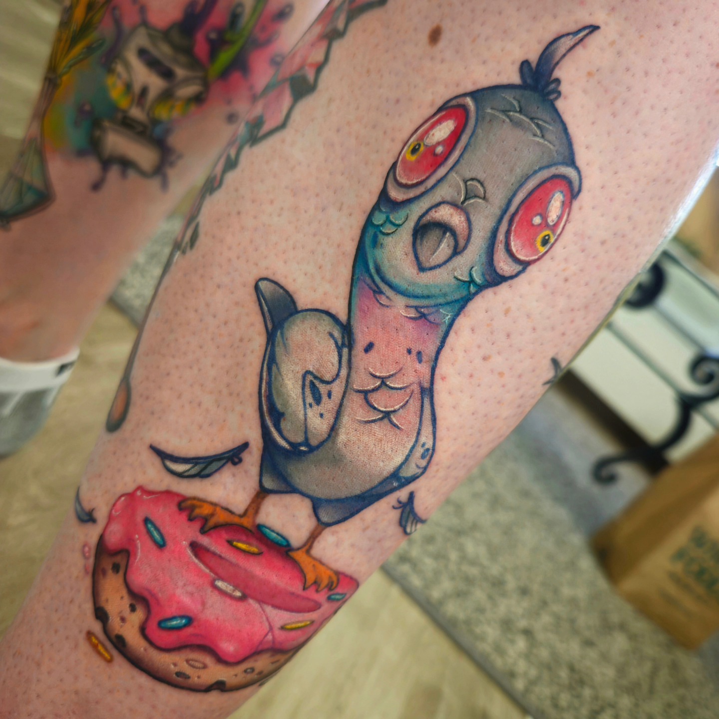 Koi fish and donut American traditional tattoo on the forearm by Angell Tattoo Artist, Denver, Colorado