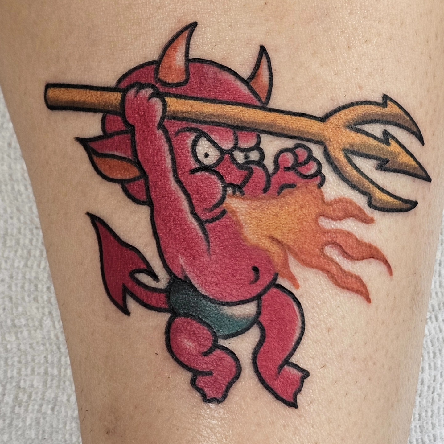 Red devil with pitchfork American traditional tattoo on the forearm by BZ Artistry