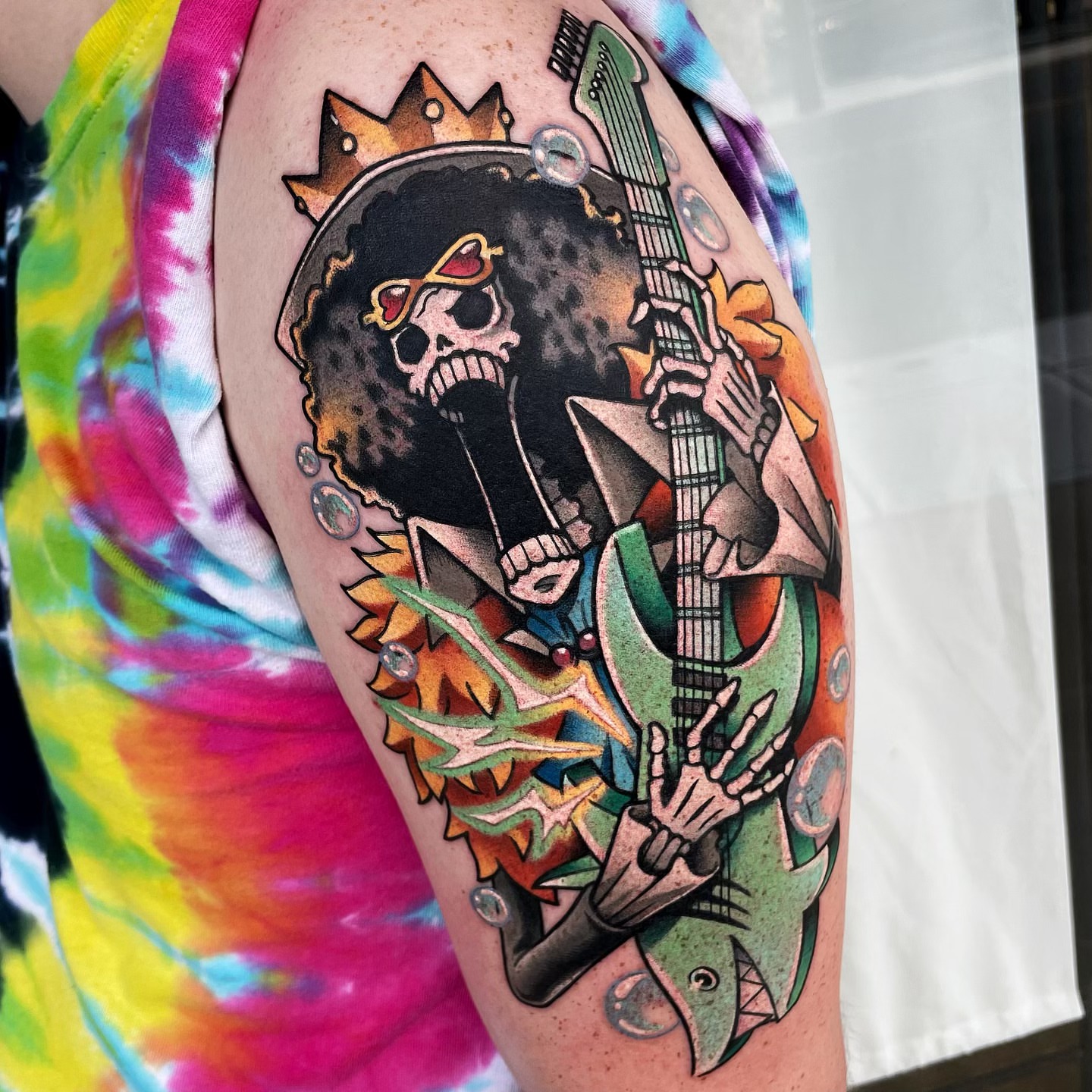 Skeleton playing guitar new school tattoo on the forearm by Bold Anime Tattoos