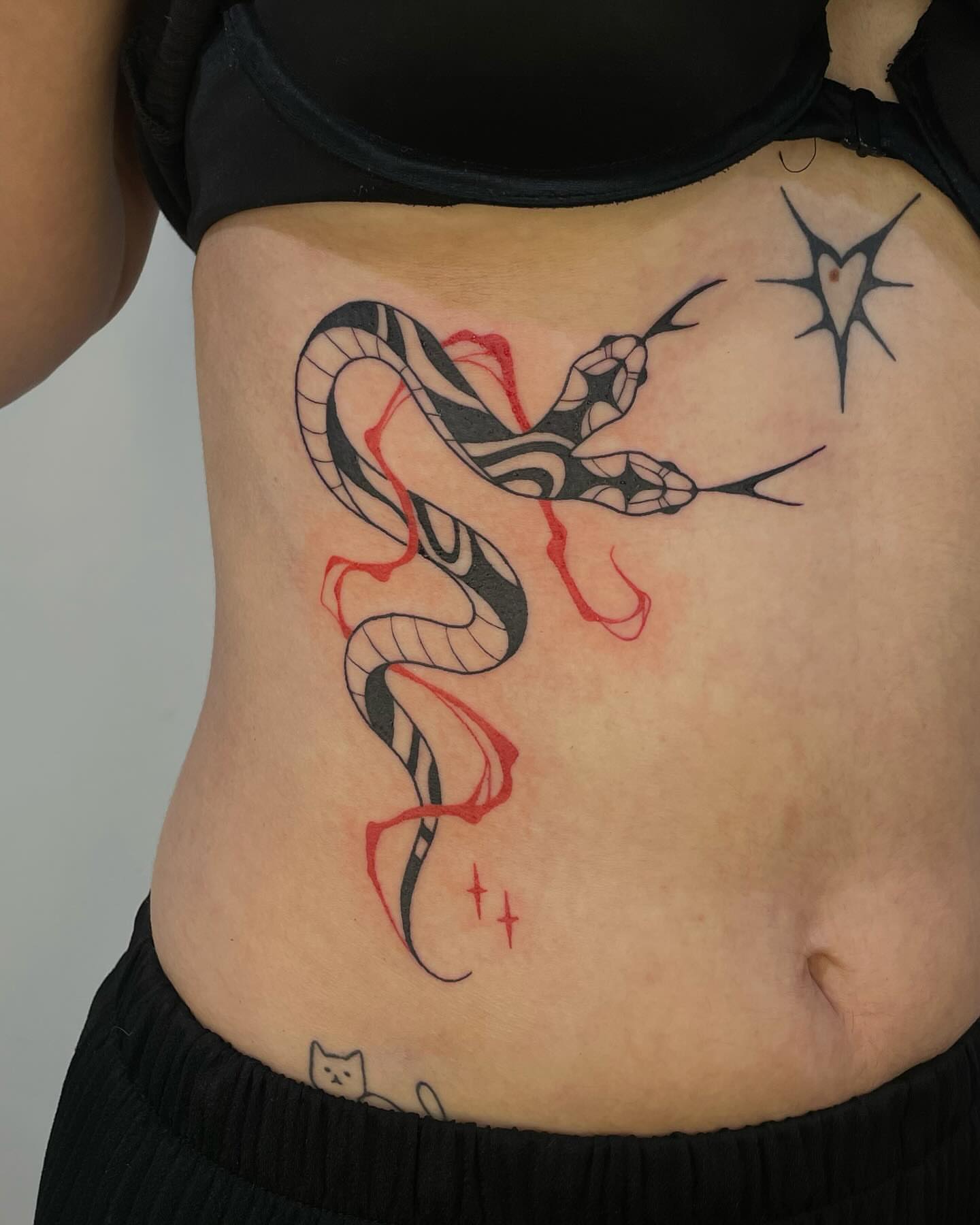 Snake geometric tattoo on the torso by sarah ✶