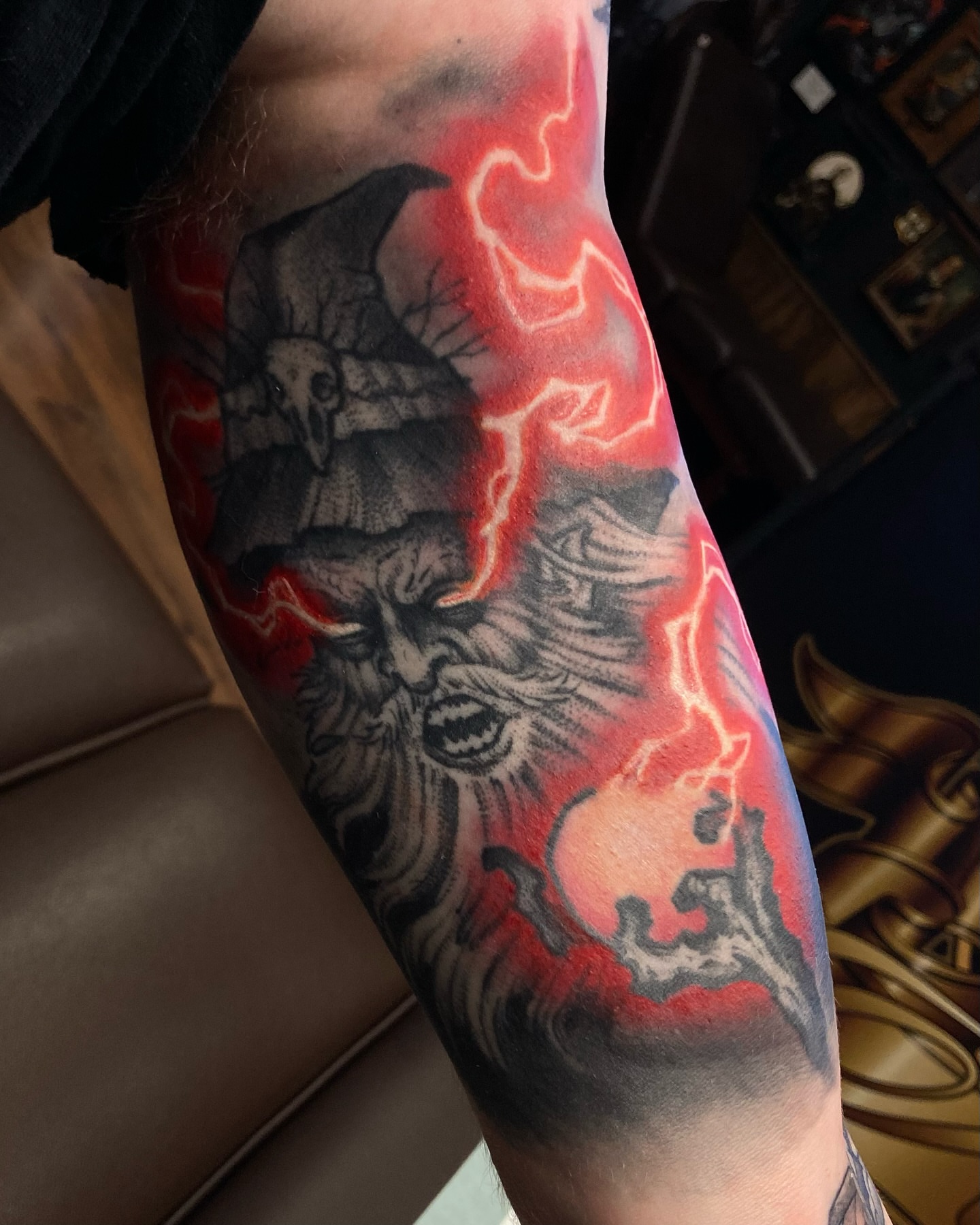 Demons and lightning realism tattoo on the forearm by Griffin Benson