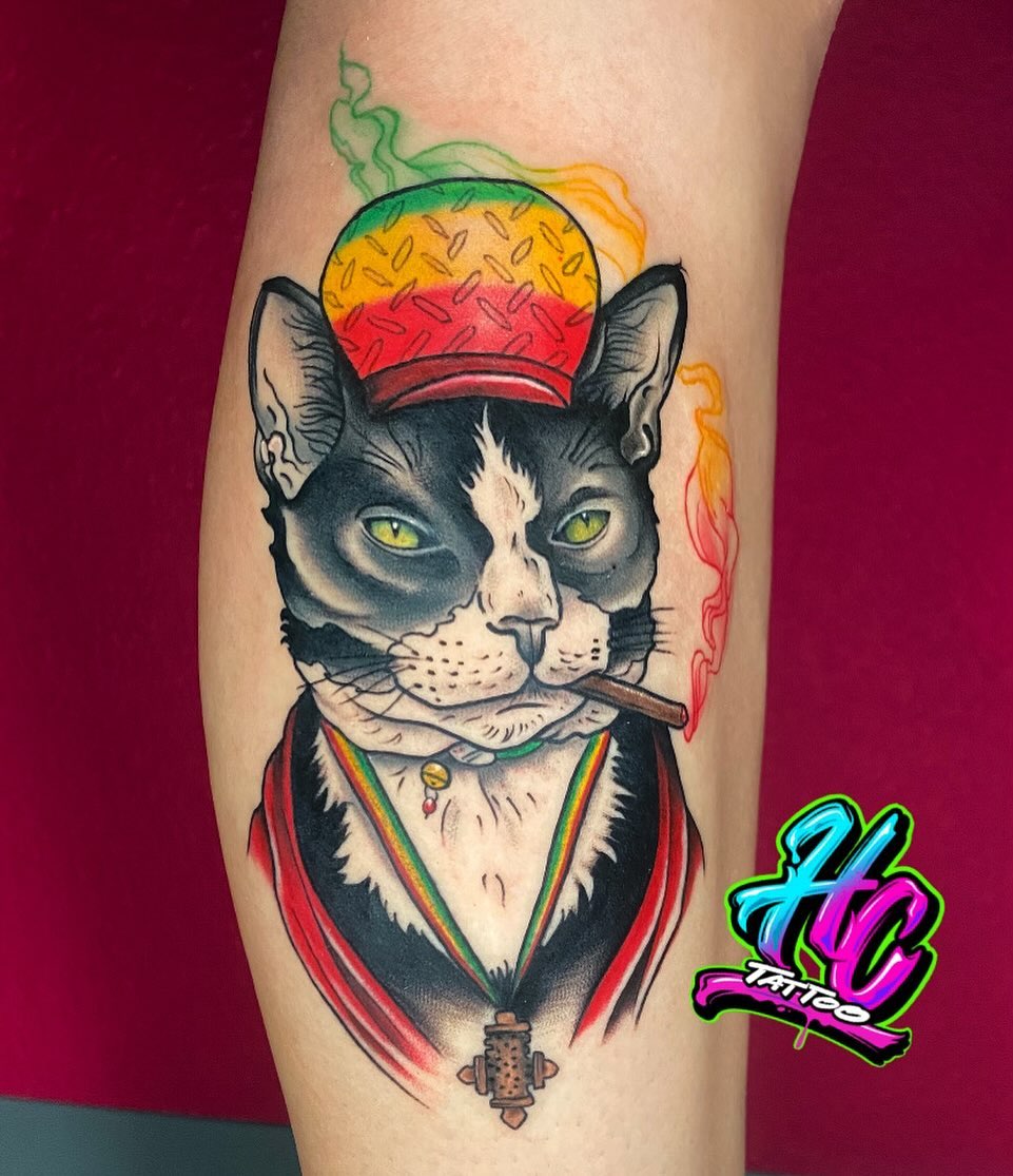 Cat with rasta hat new school tattoo on the forearm by Chelsey Moore, Albuquerque, New Mexico