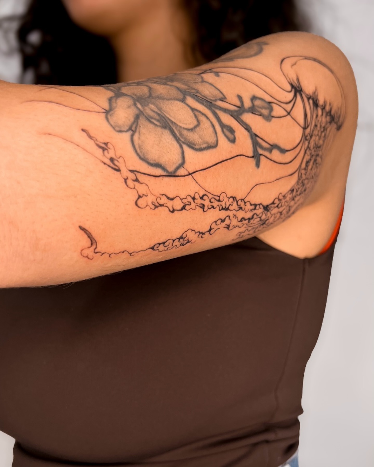 Flower and wave black and grey tattoo on the forearm by ᴀmb⃘er