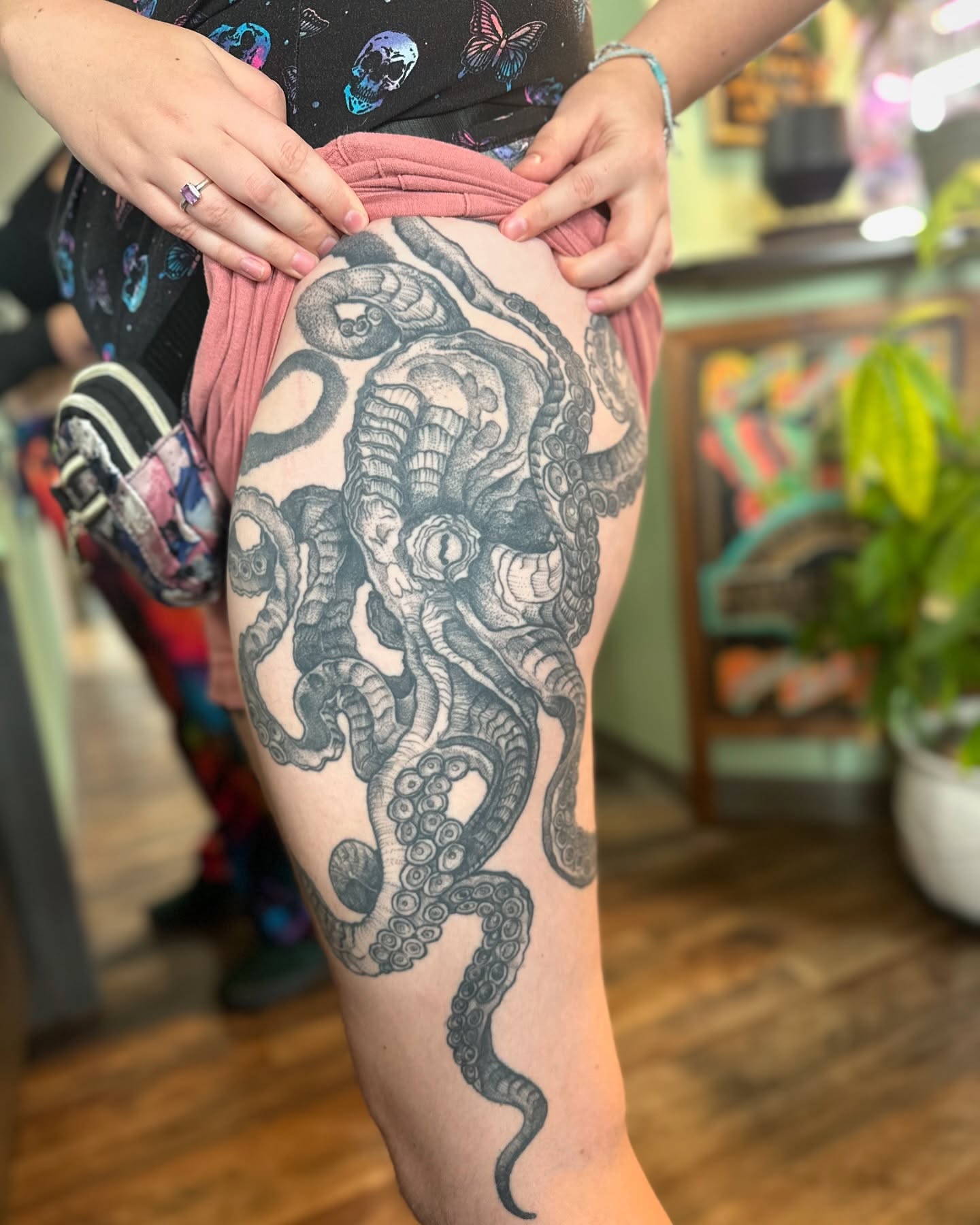 Octopus black and grey tattoo on the thigh by Benjamin Carlson
