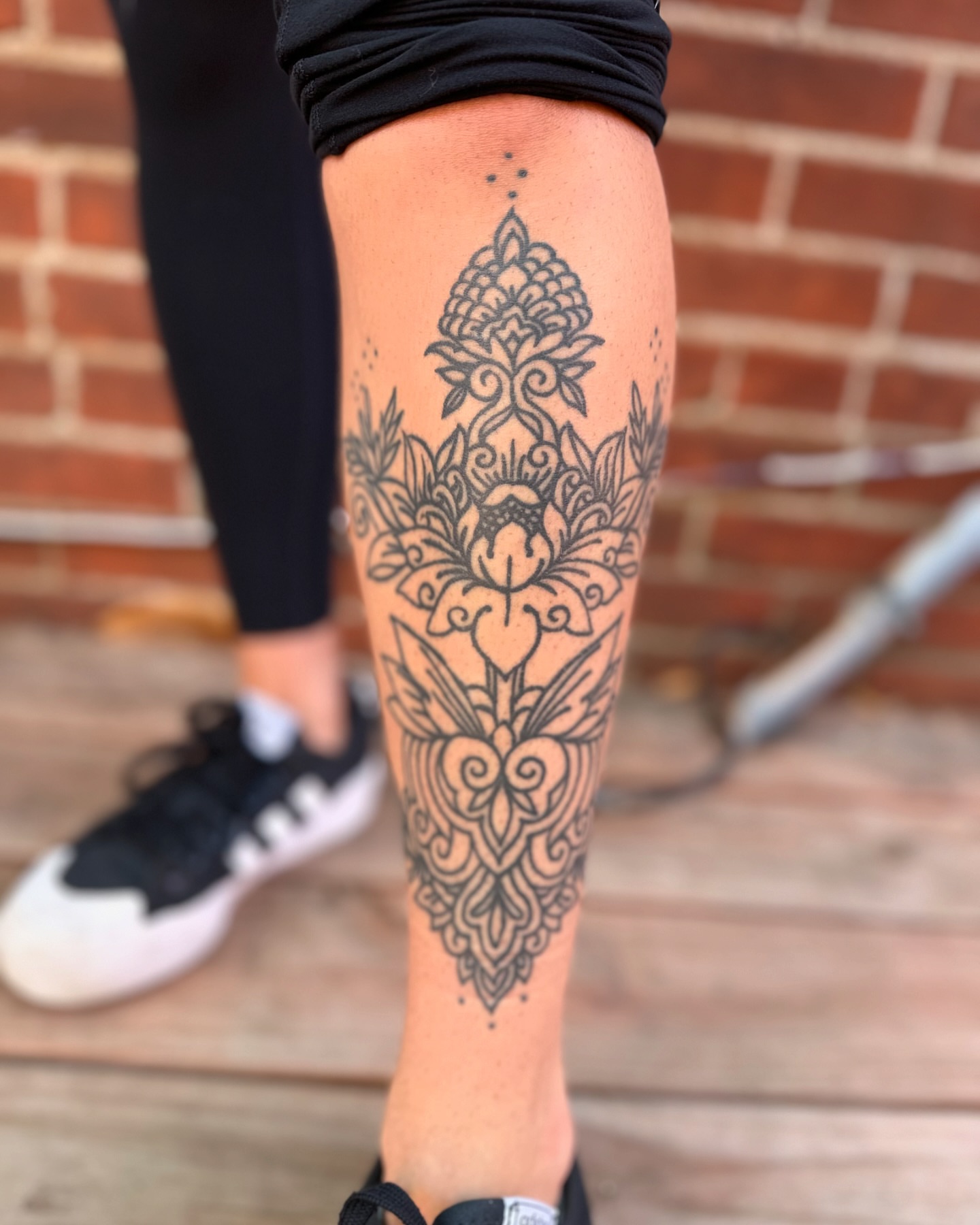 Floral mandala ornamental tattoo on the calf by Benjamin Carlson