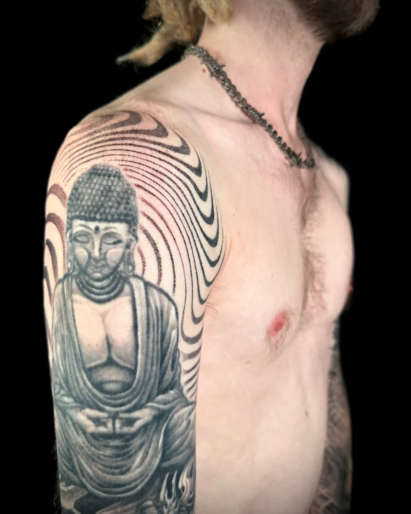 Buddha statue dotwork tattoo on the shoulder by Chelsey