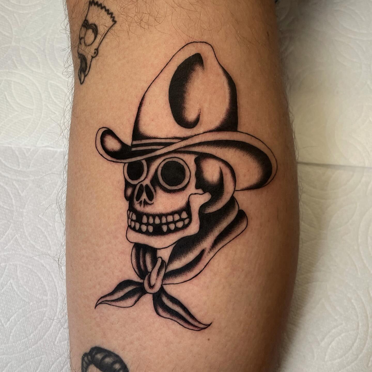 Cowboy skull black and grey tattoo on the forearm by Niko Mulhearn