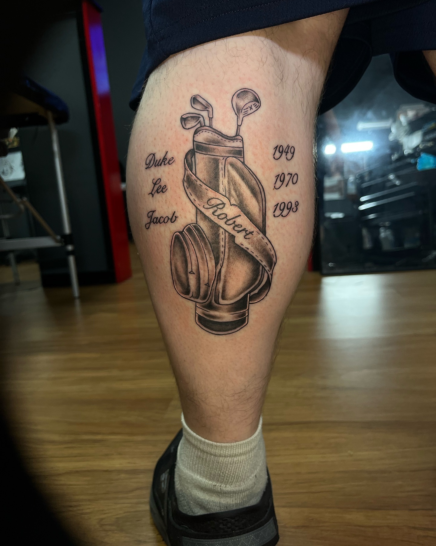 Golf bag realism tattoo on the thigh by Connor Arvay
