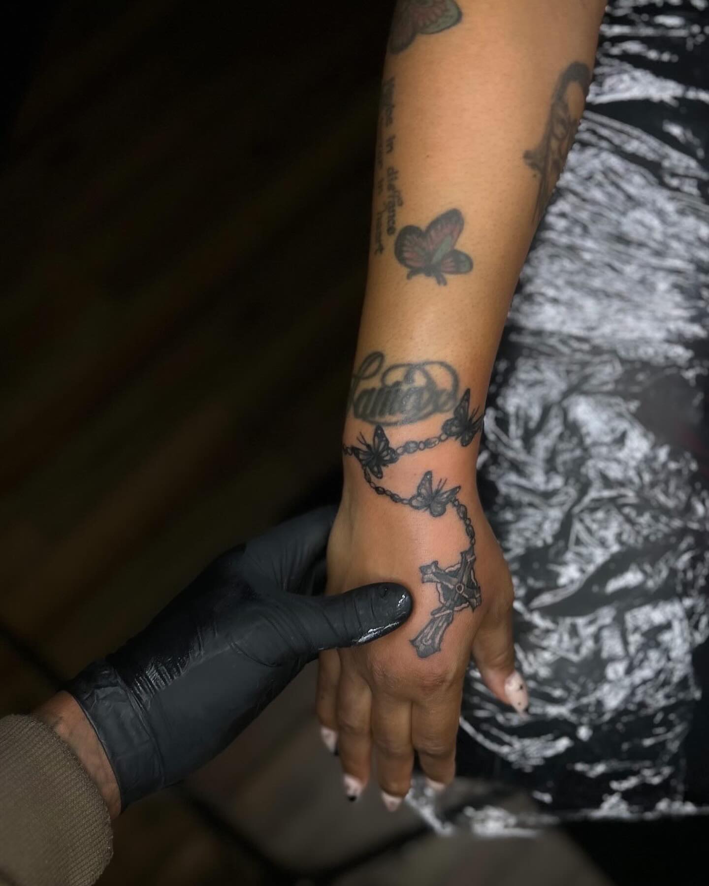 Cross and chain black and grey tattoo on the hand by Rell Washington, Marlow Heights, Maryland