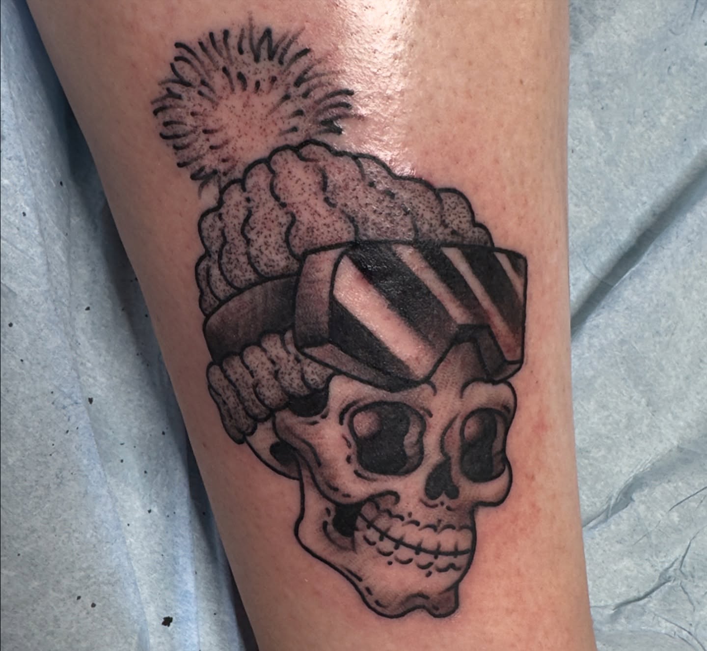 Skull with pompadour black and grey tattoo on the forearm by 𝙹𝚎𝚗 ♡︎