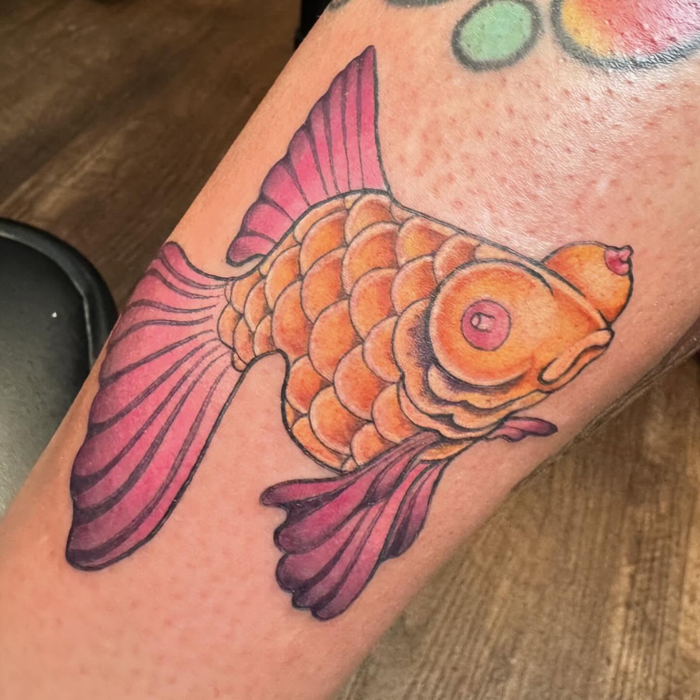 Koi fish American traditional tattoo on the forearm by Michele Estes