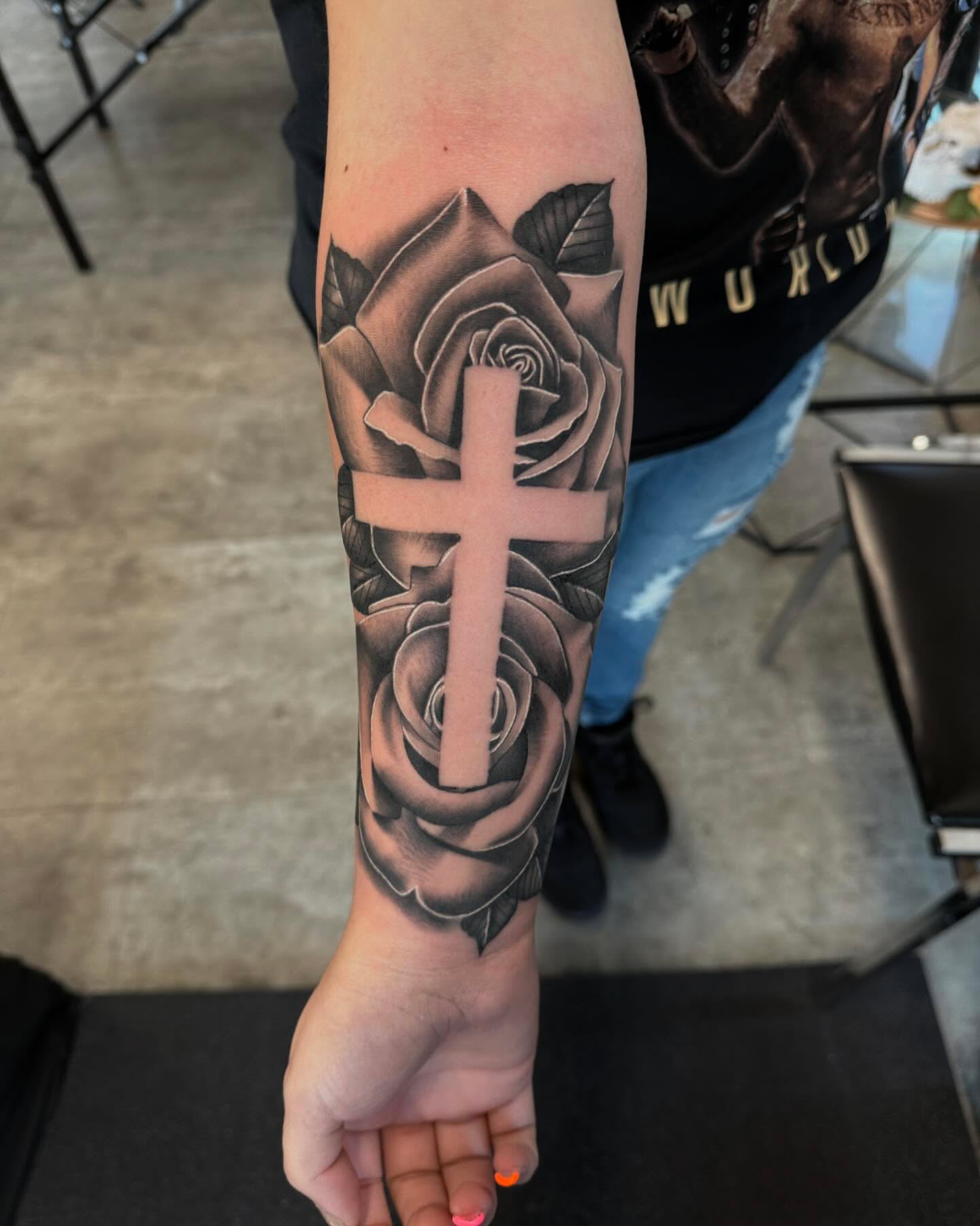 Cross and roses realism tattoo on the forearm by Aaron Carey, Salem, Oregon