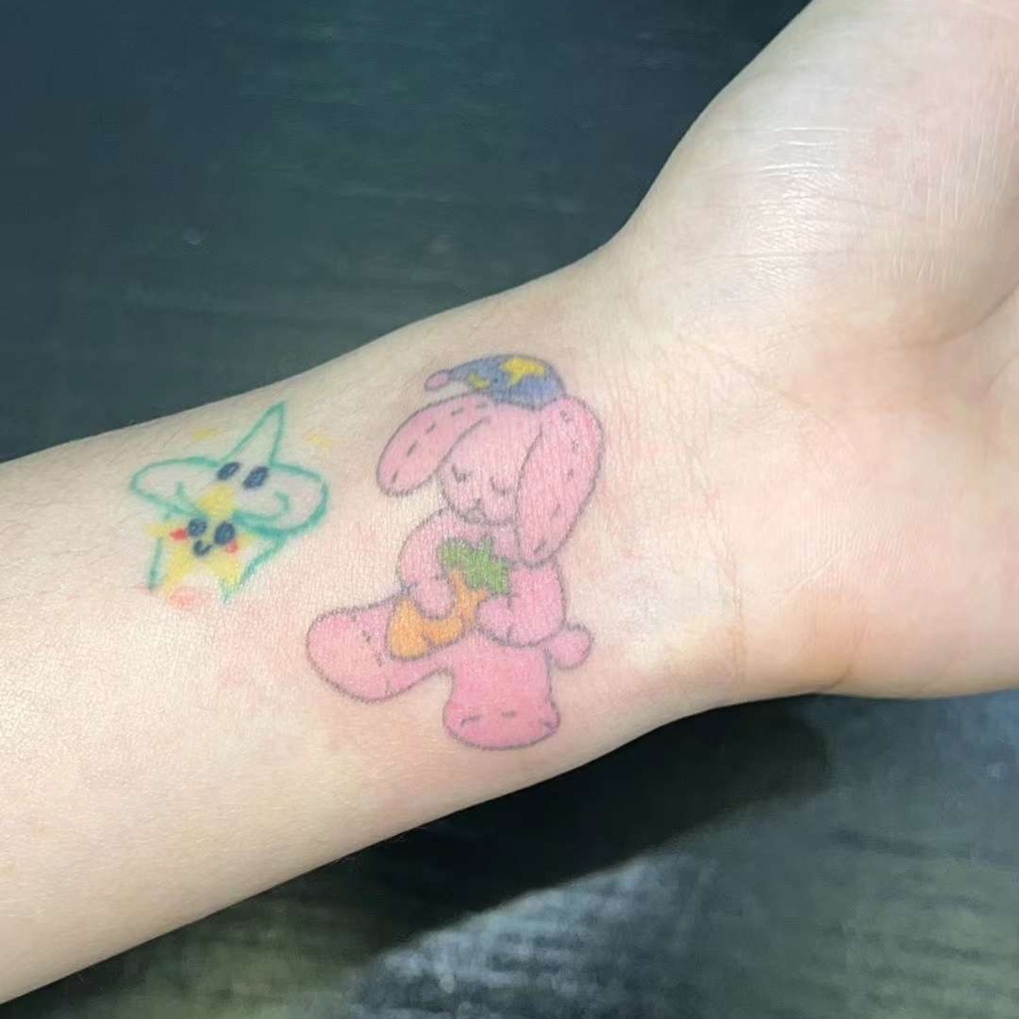 Pink bunny holding a flower dotwork tattoo on the forearm by Charlie