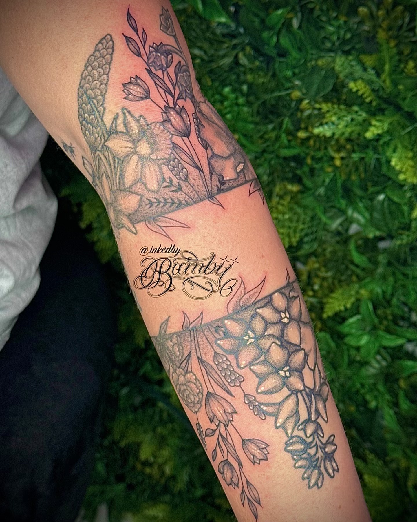 Floral arrangement black and grey tattoo on the forearm by Ember