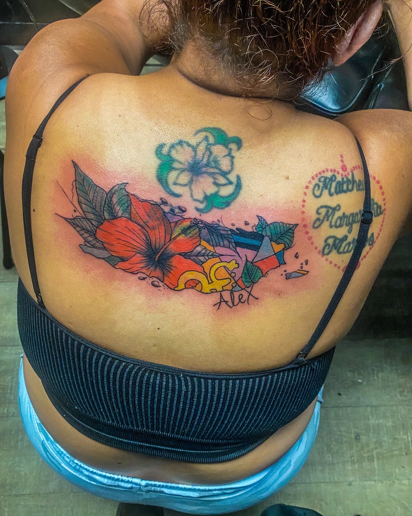 Floral arrangement new school tattoo on the back by Rico Rosario
