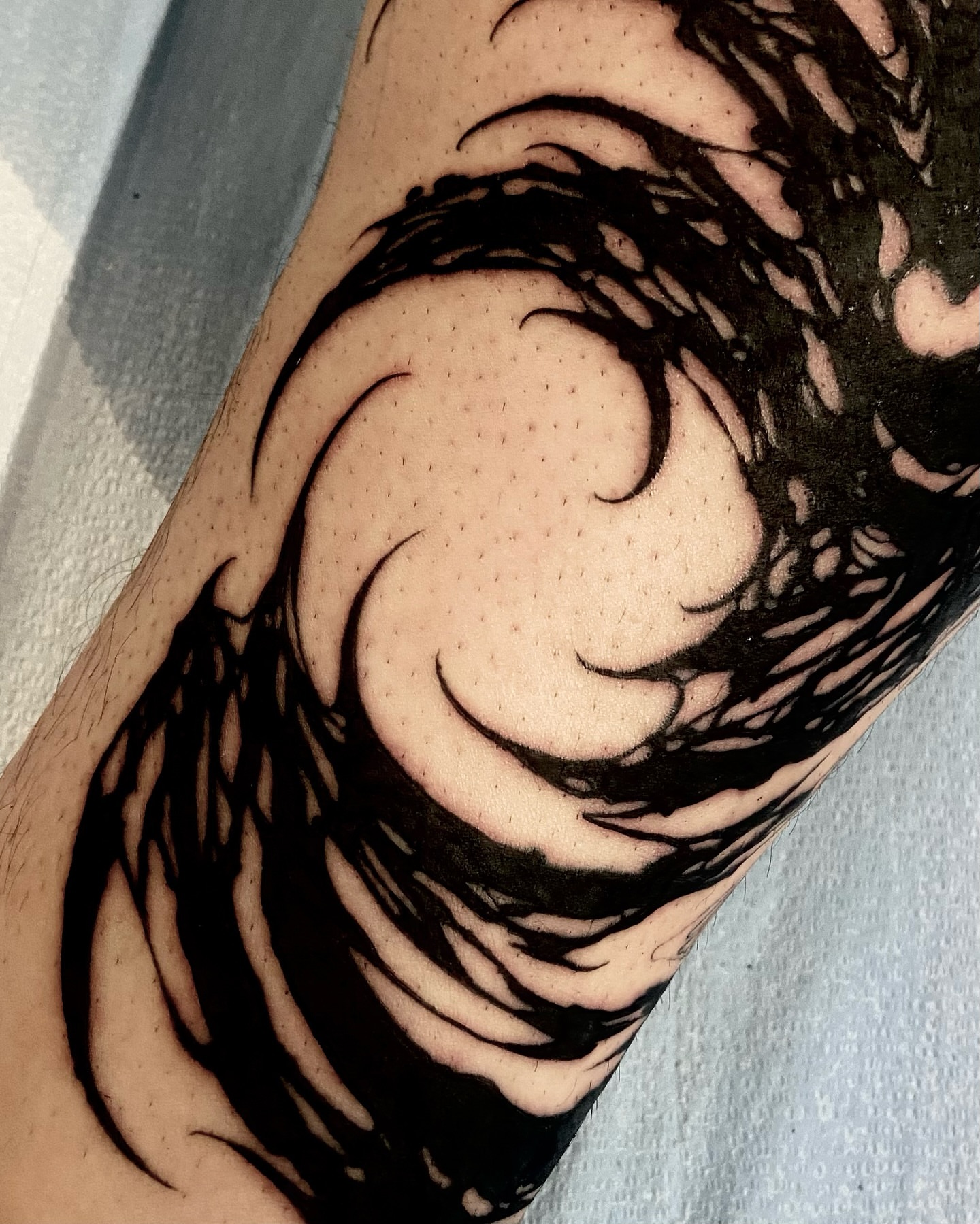Wave black and grey tattoo on the forearm by Nathan