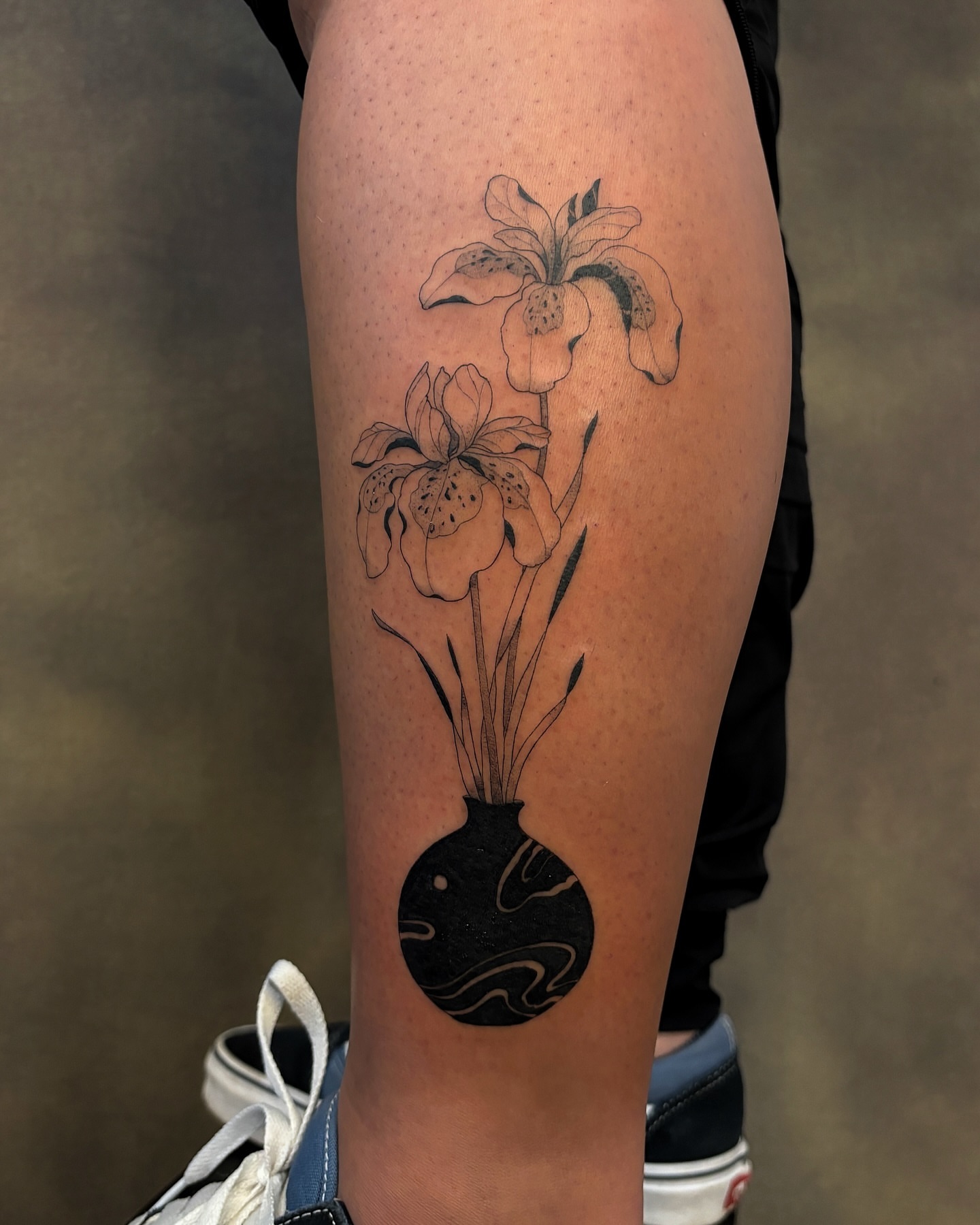 Flowers in vase black and grey tattoo on the thigh by sago, Berkeley, California