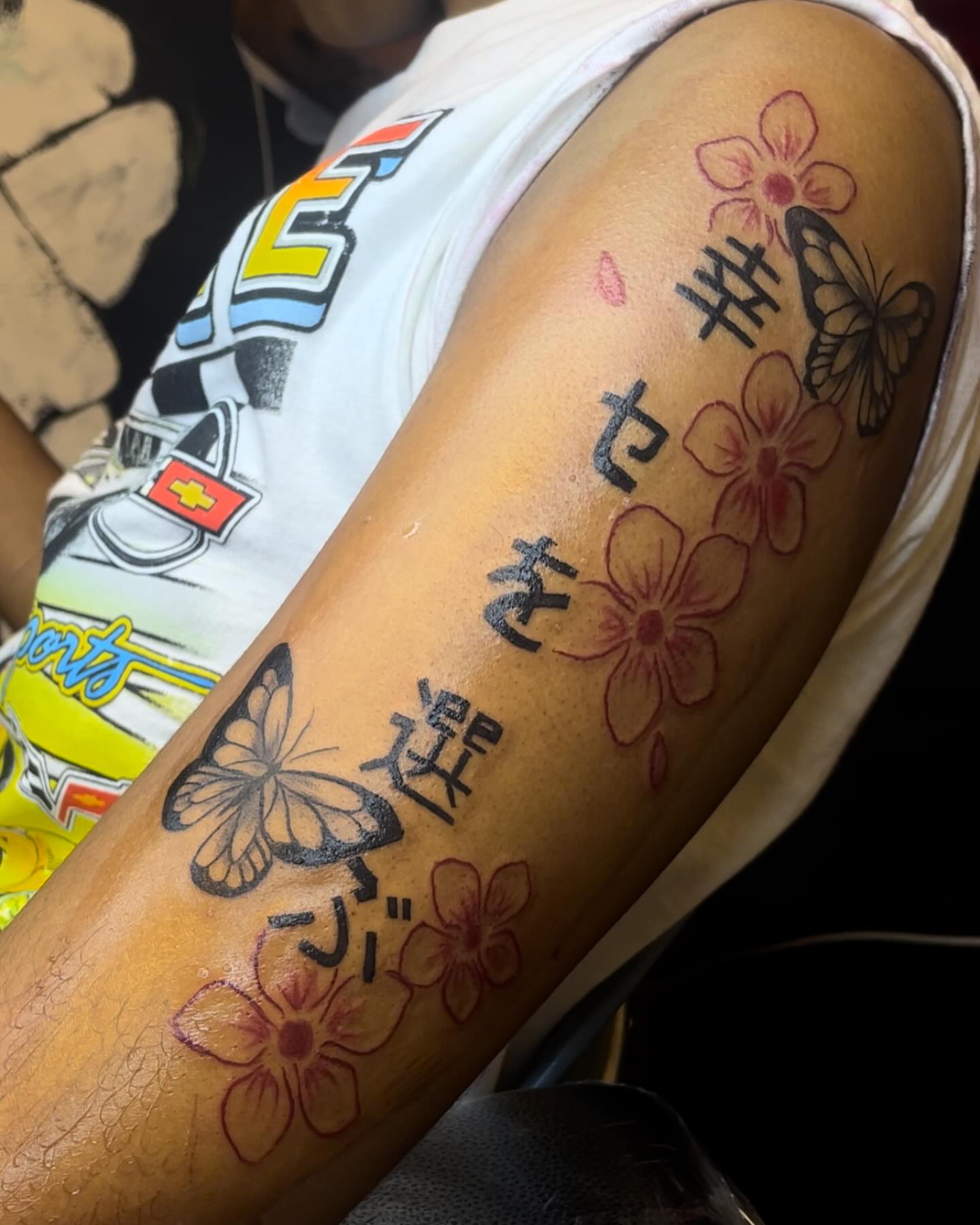 Cherry blossoms and butterflies japanese irezumi tattoo on the forearm by Dinero Inks