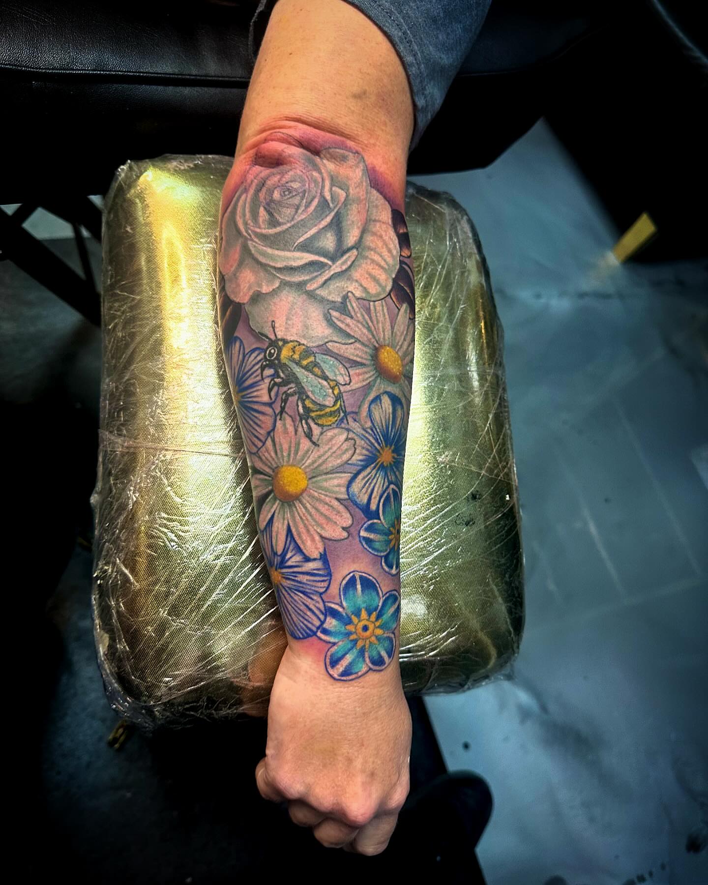 Flower bouquet realism tattoo on the forearm by Labbé