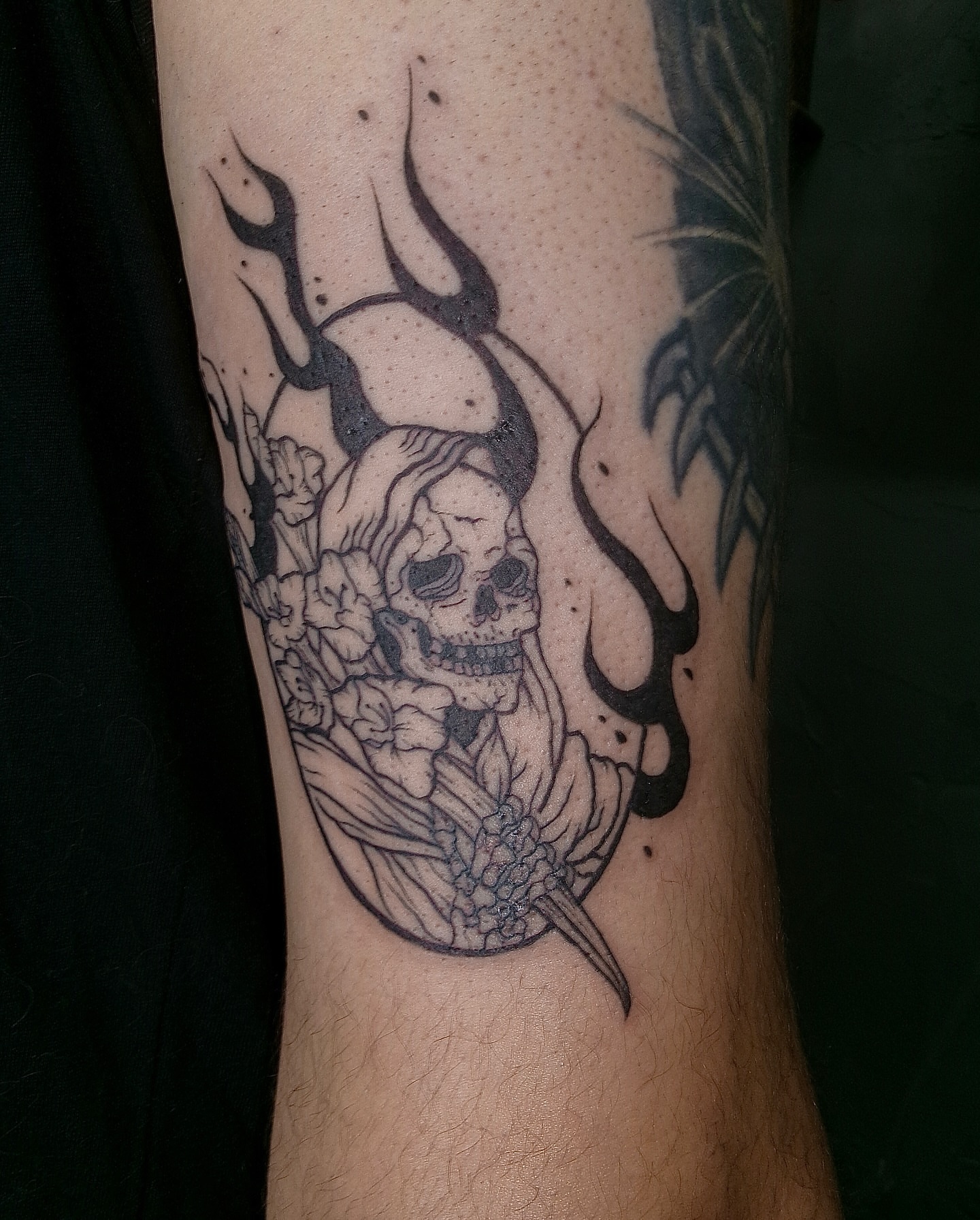 Floral skull realism tattoo on the forearm by Rebel milly Tattoo