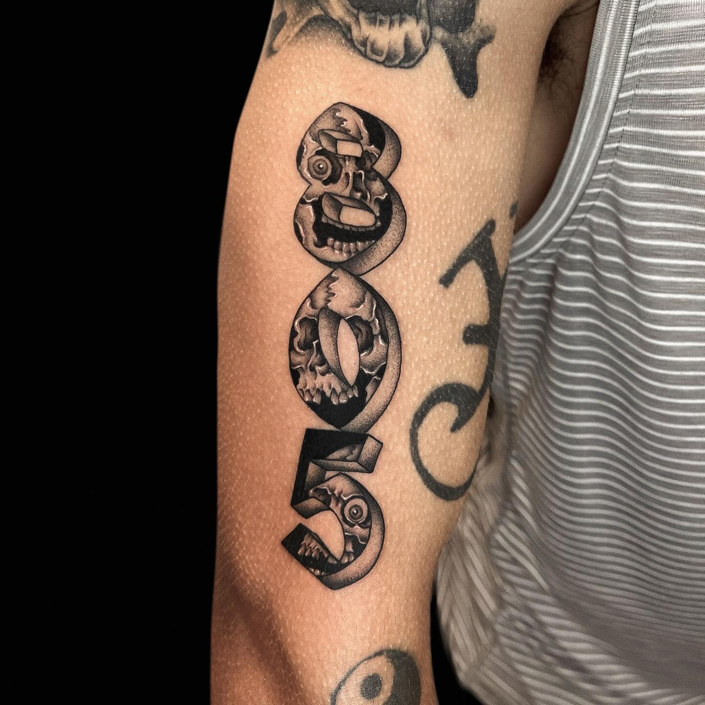 Skull black and grey tattoo on the forearm by Jason