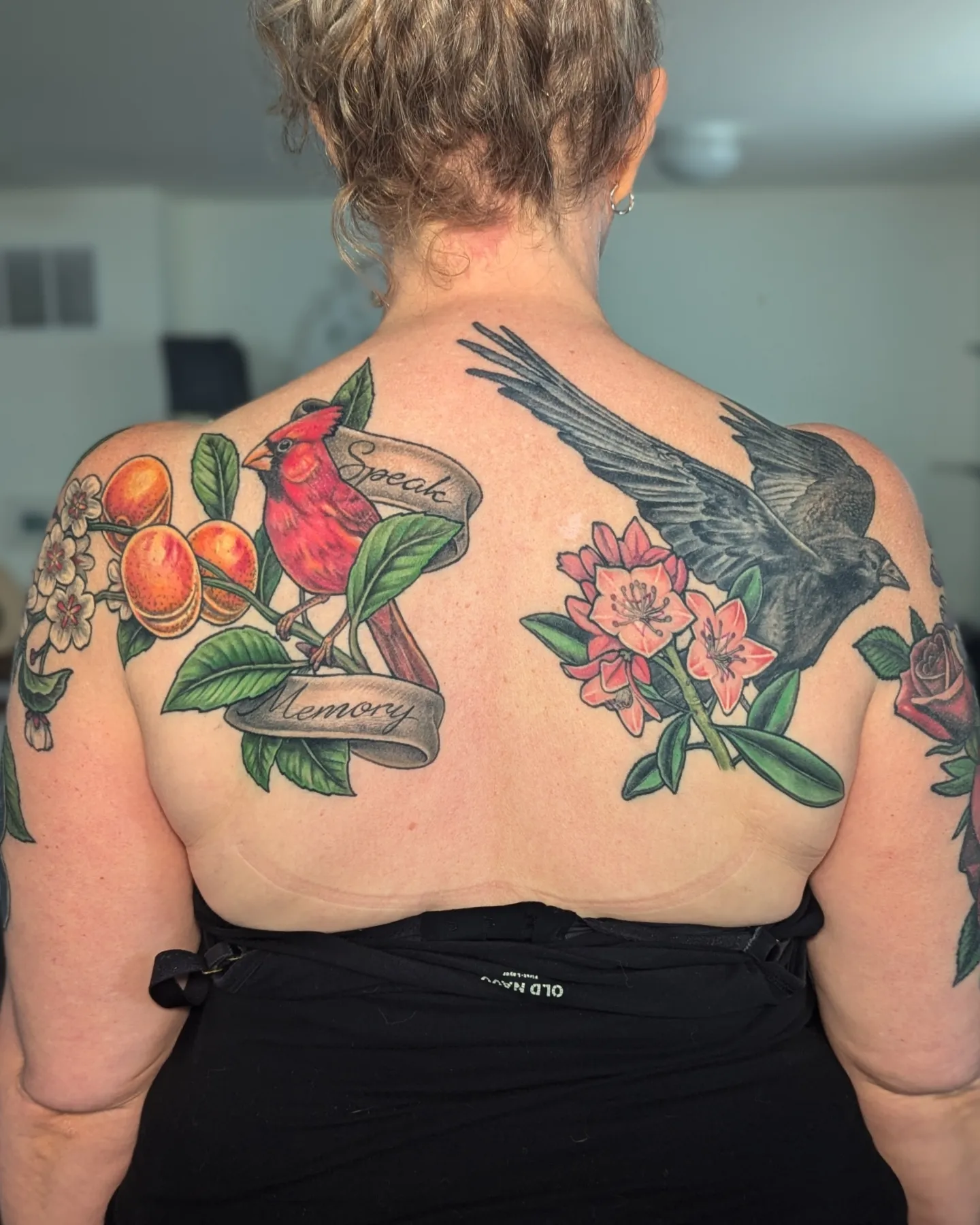 Bird and floral arrangement realism tattoo on the back by Jay Trip