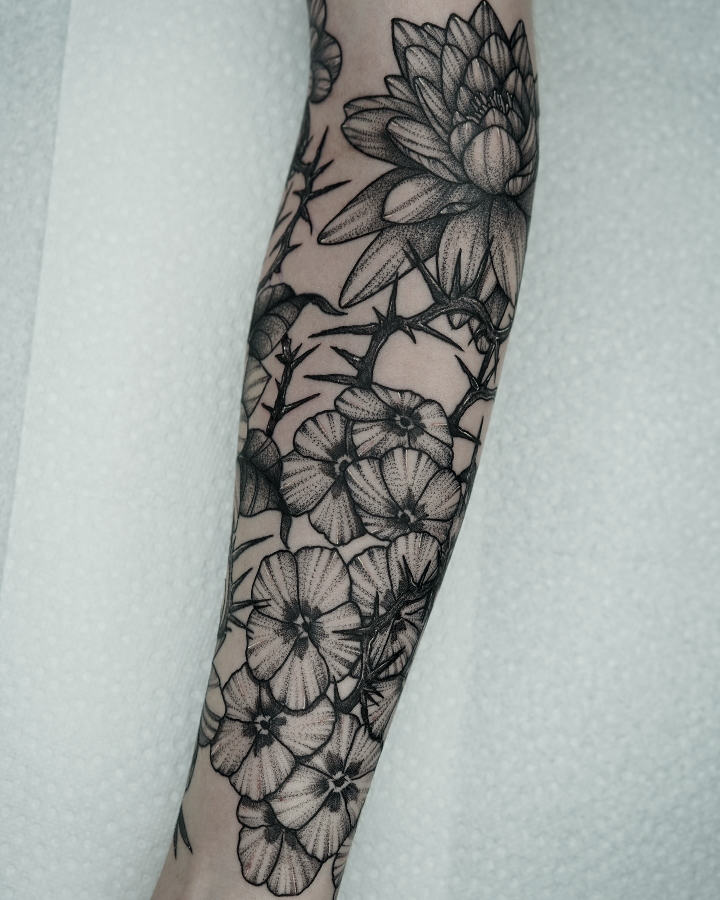 Flowers dotwork tattoo on the forearm by Tony Murray