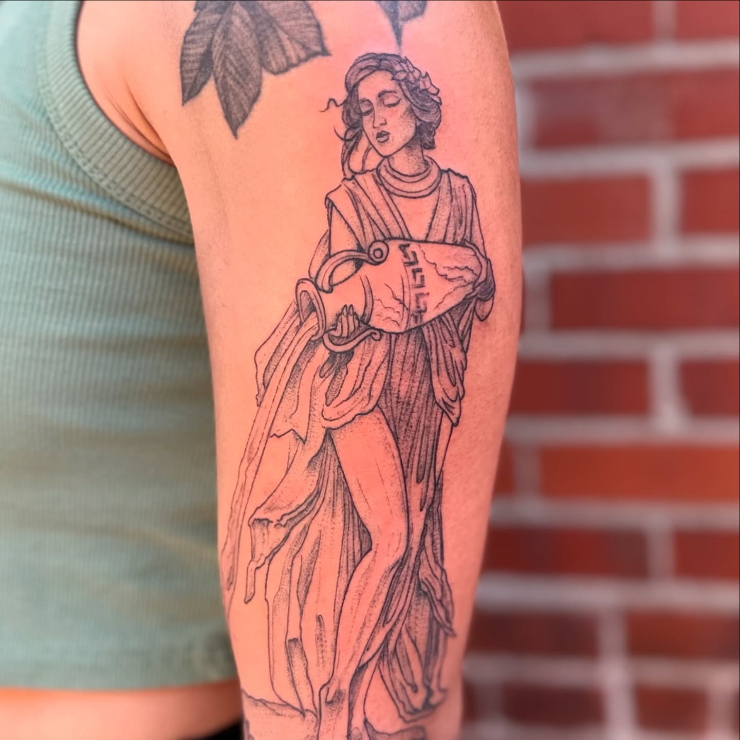 Statue of woman black and grey tattoo on the forearm by Benjamin Carlson