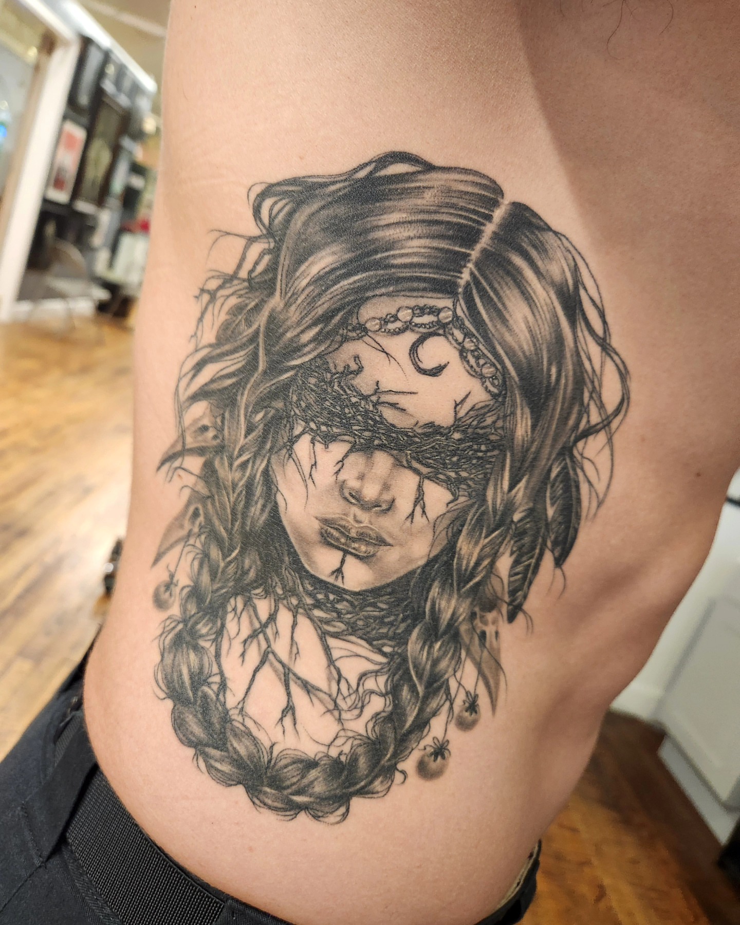 Woman with roots realism tattoo on the ribs by Heather