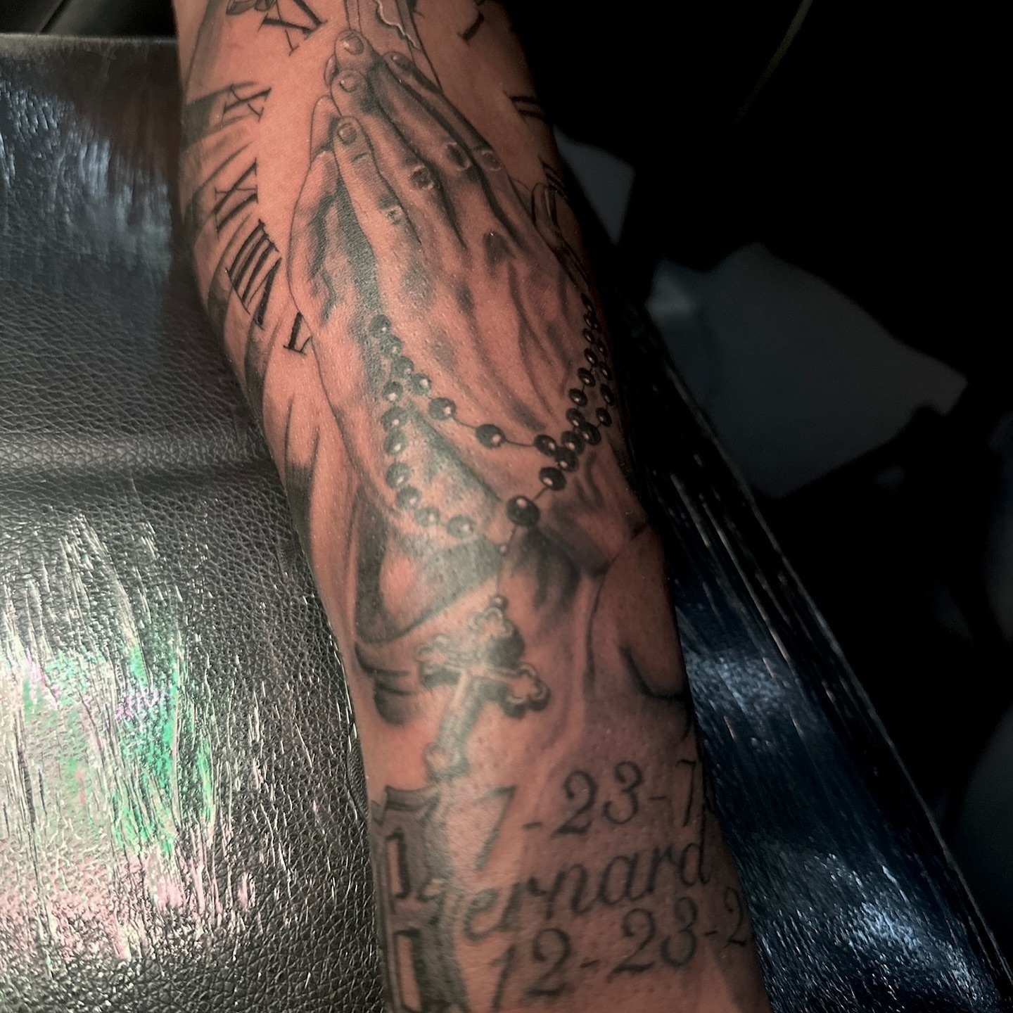 Praying hands with rosary black and grey tattoo on the forearm by ᴡᴏʀᴍ