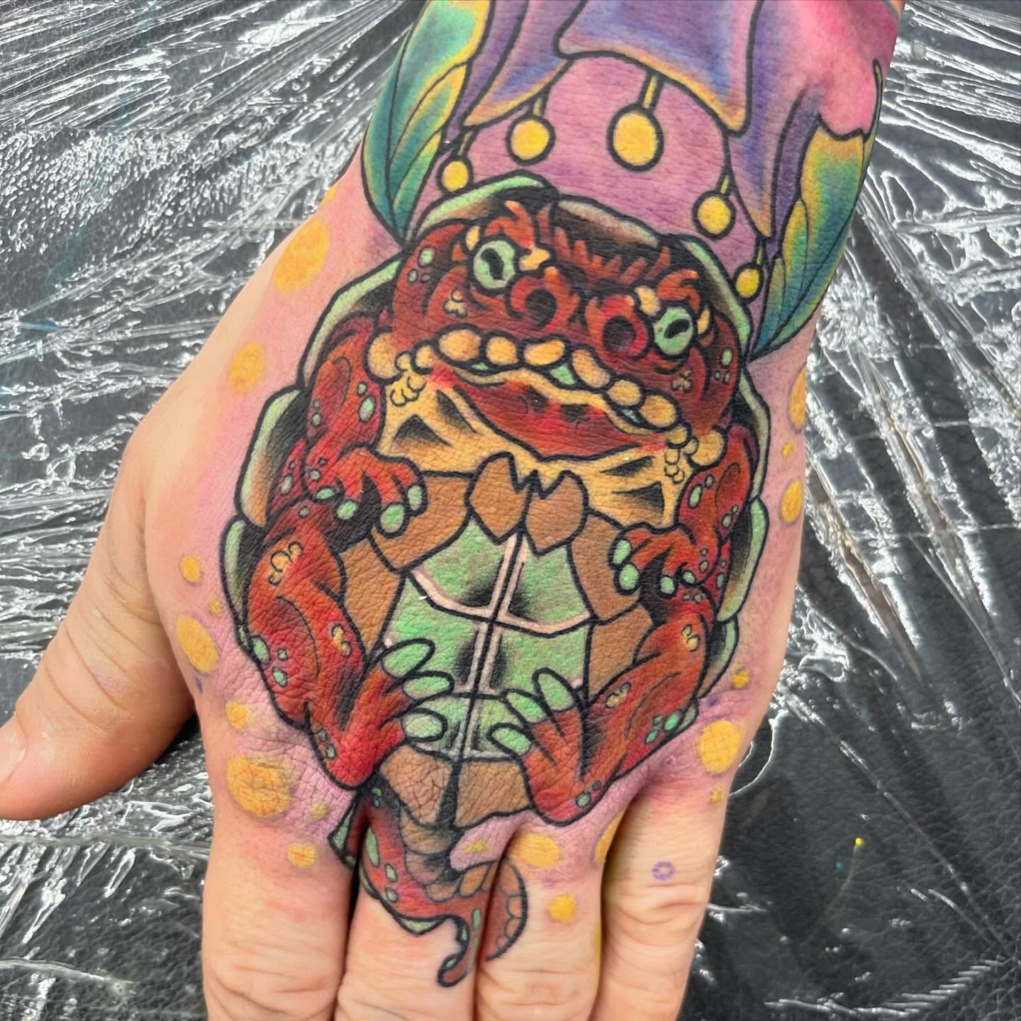 Frog American traditional tattoo on the hand by Autumn Fulford