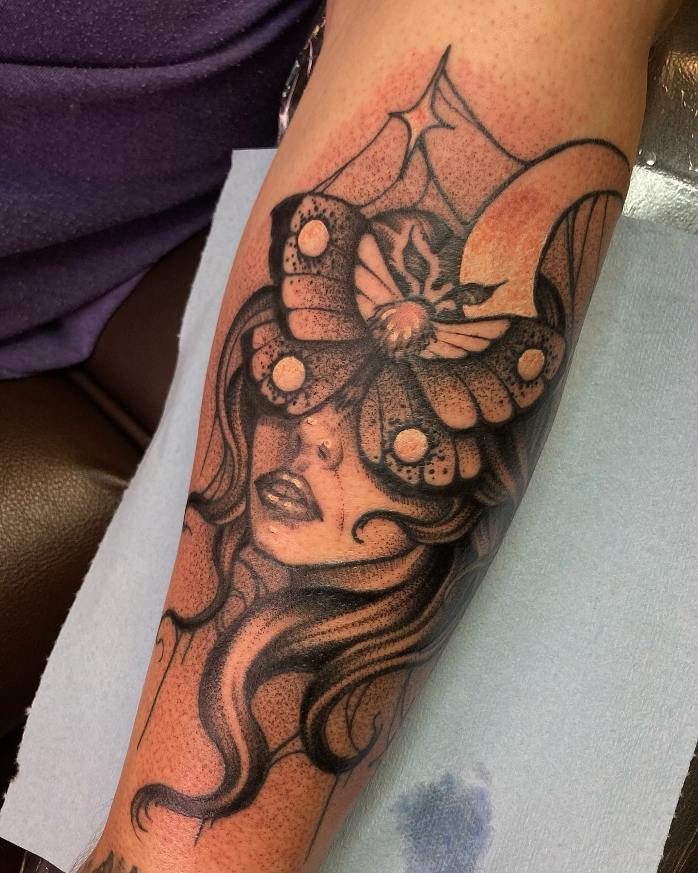 Woman with butterfly dotwork tattoo on the forearm by Griffin Benson