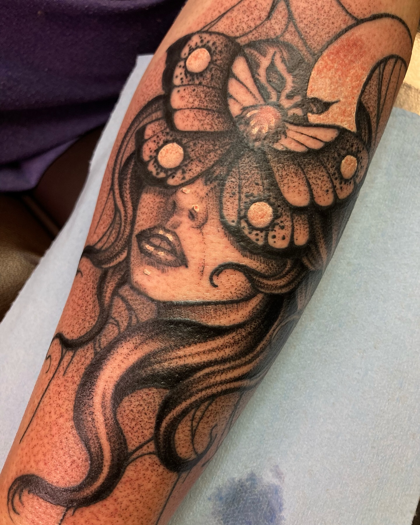 Woman with butterfly dotwork tattoo on the forearm by Griffin Benson