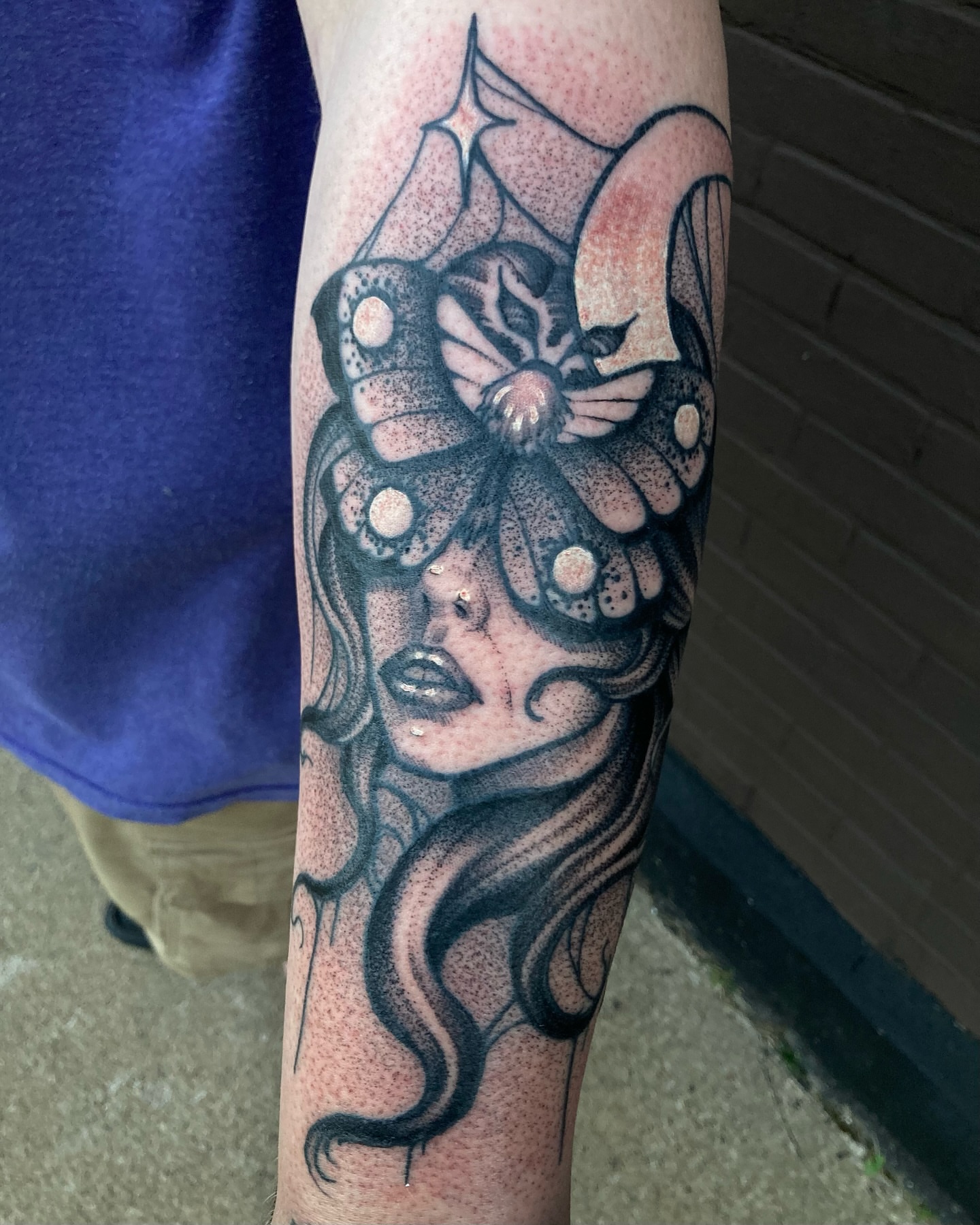 Woman with butterfly dotwork tattoo on the forearm by Griffin Benson