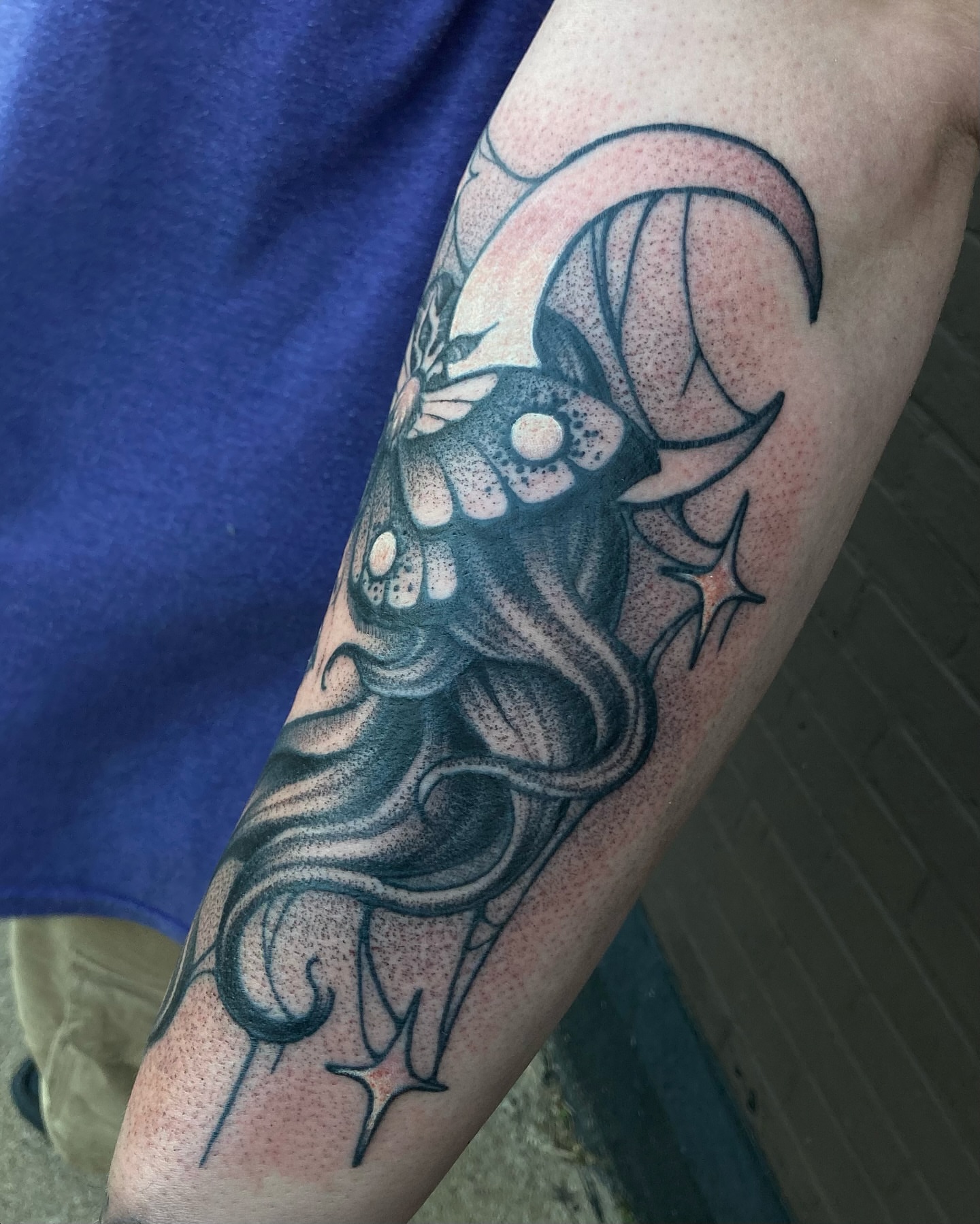 Skull with tentacles dotwork tattoo on the forearm by Griffin Benson