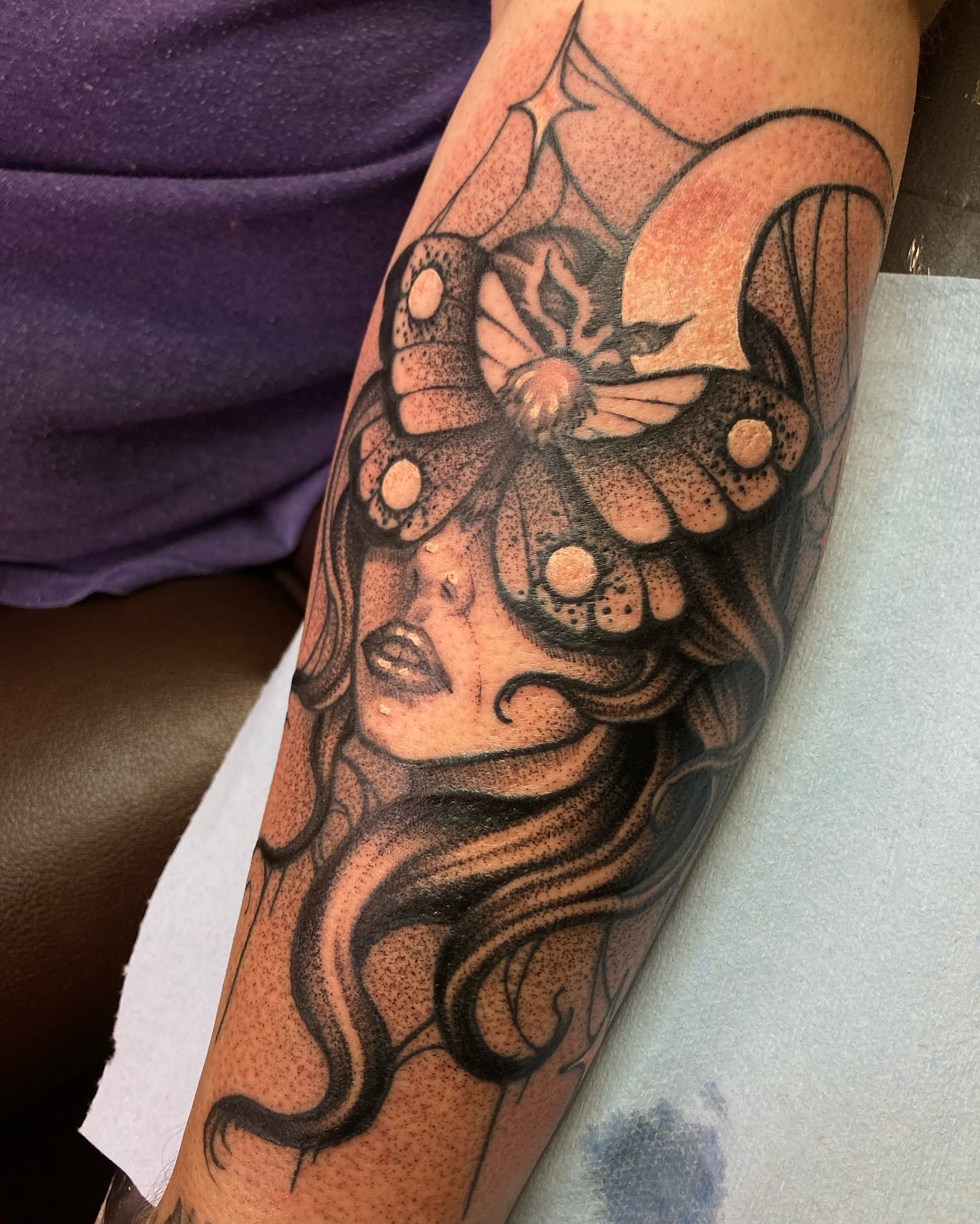 Woman with butterfly dotwork tattoo on the forearm by Griffin Benson