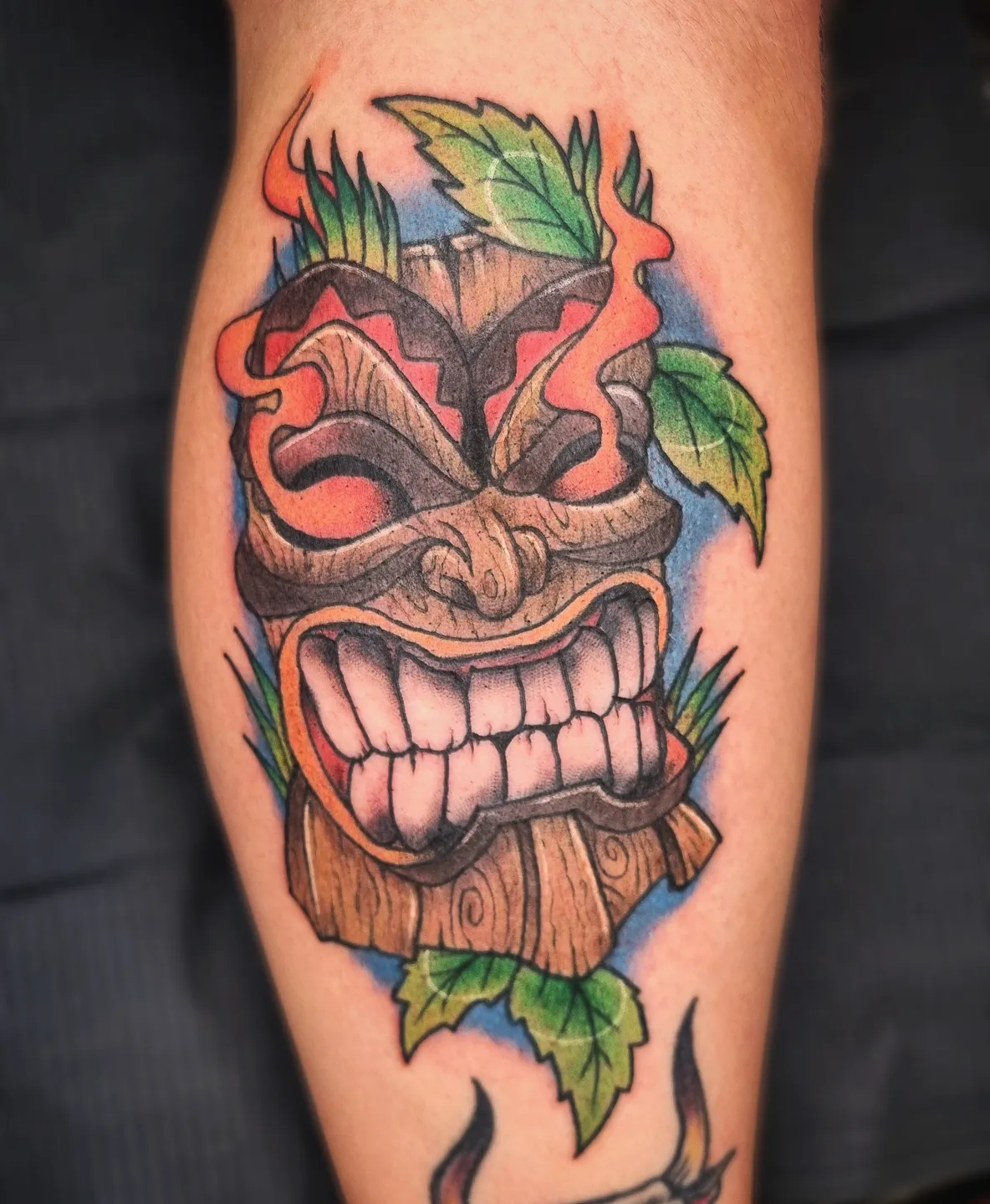 Tiki mask American traditional tattoo on the forearm by AntiheroTattoo