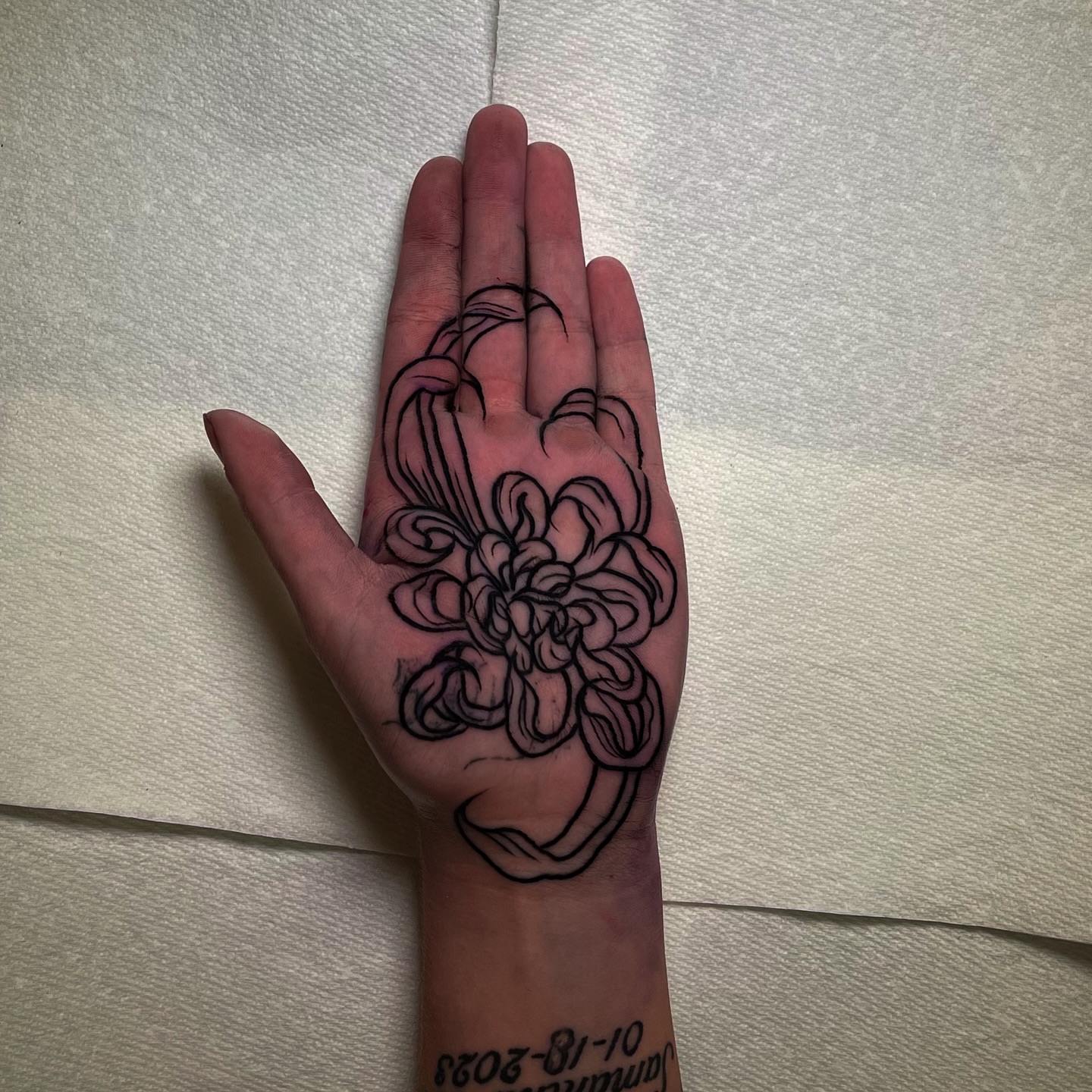 Flower black and grey tattoo on the hand by Miguel Henrik