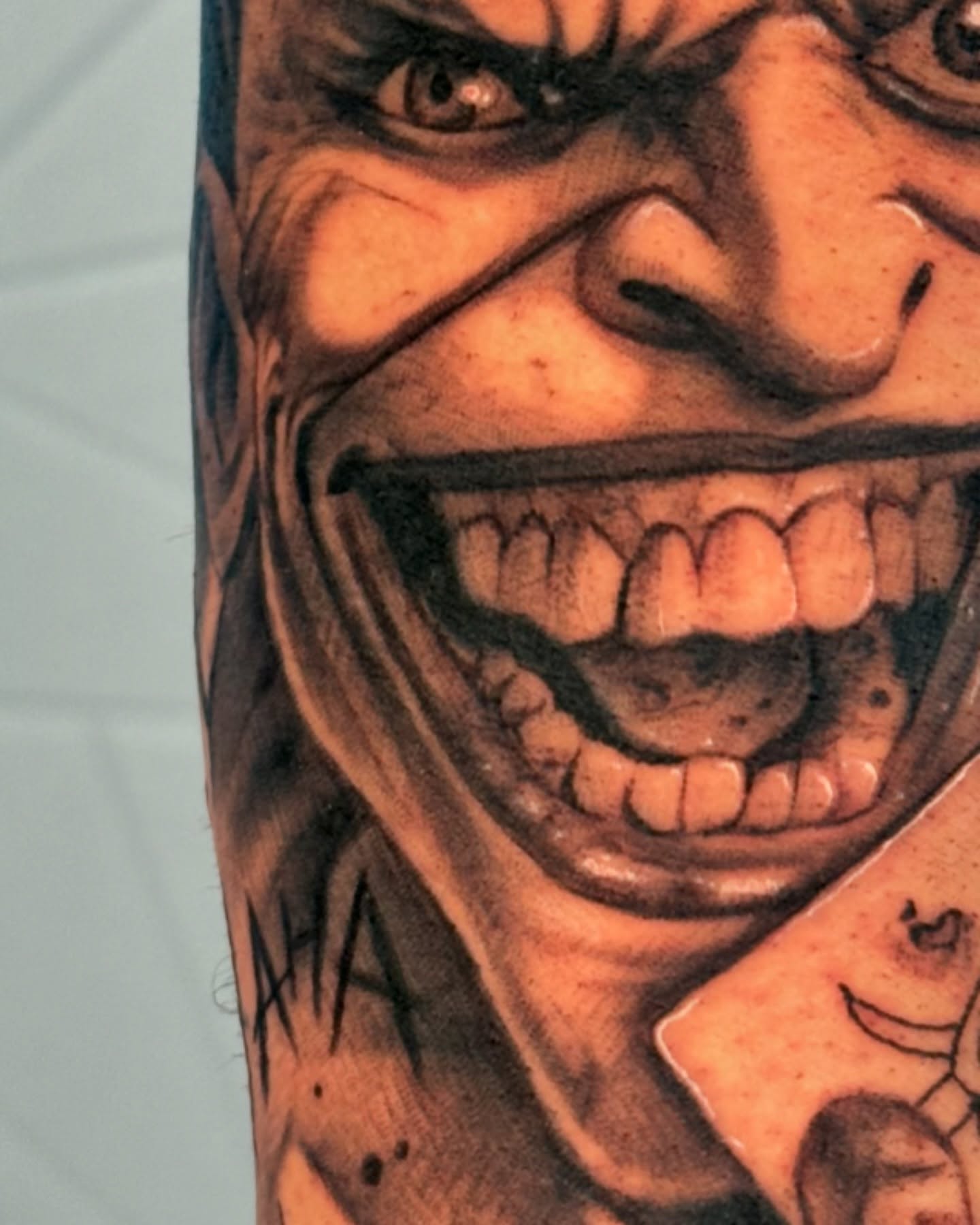 Joker realism tattoo on the forearm by Isiah Hall, Whittier, California