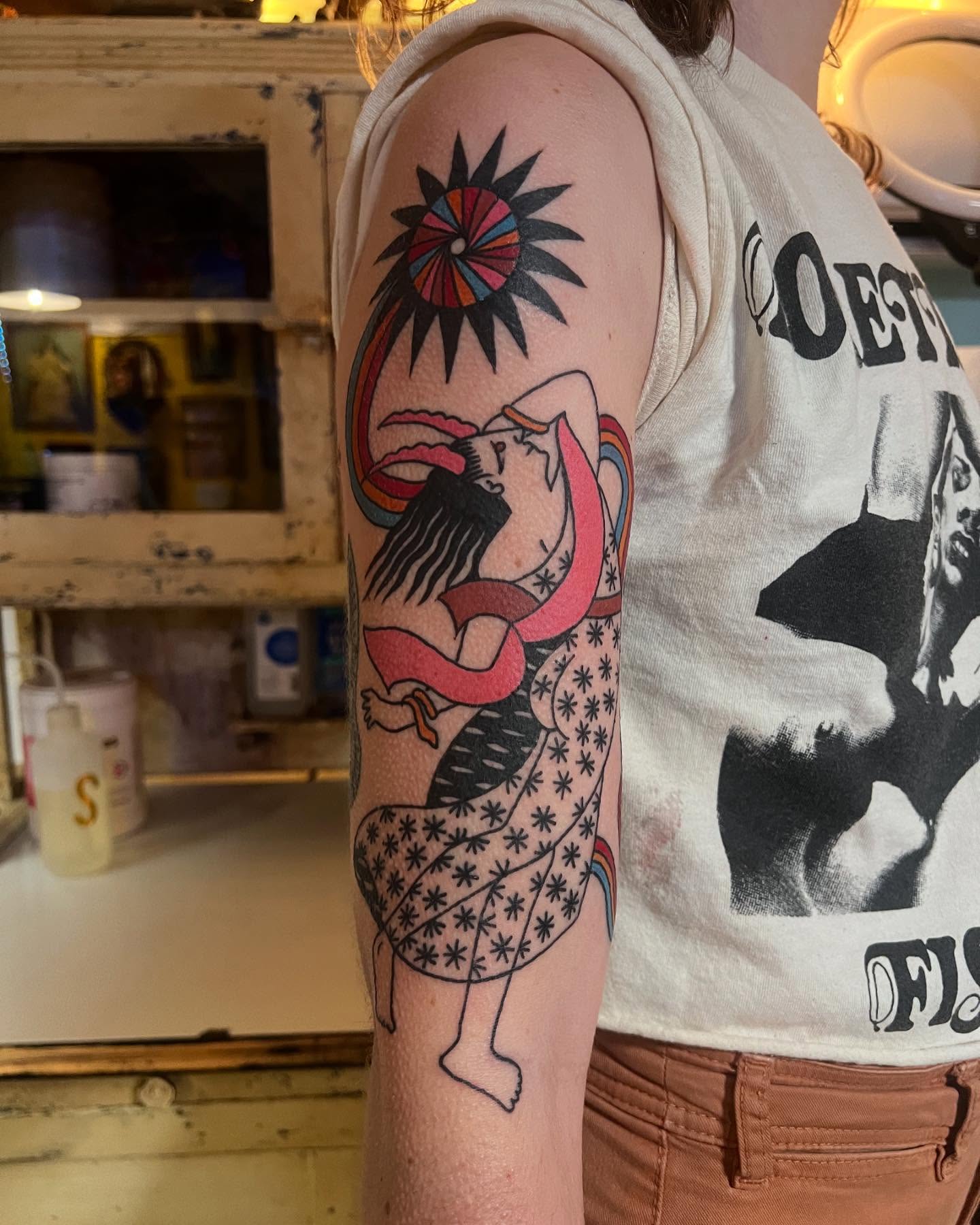 Woman with sunburst new school tattoo on the forearm by Manee Friday