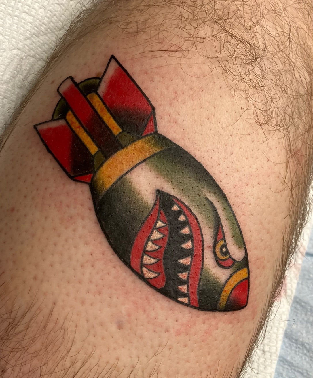 Shark bomb American traditional tattoo on the shoulder by Hunter McGinnis