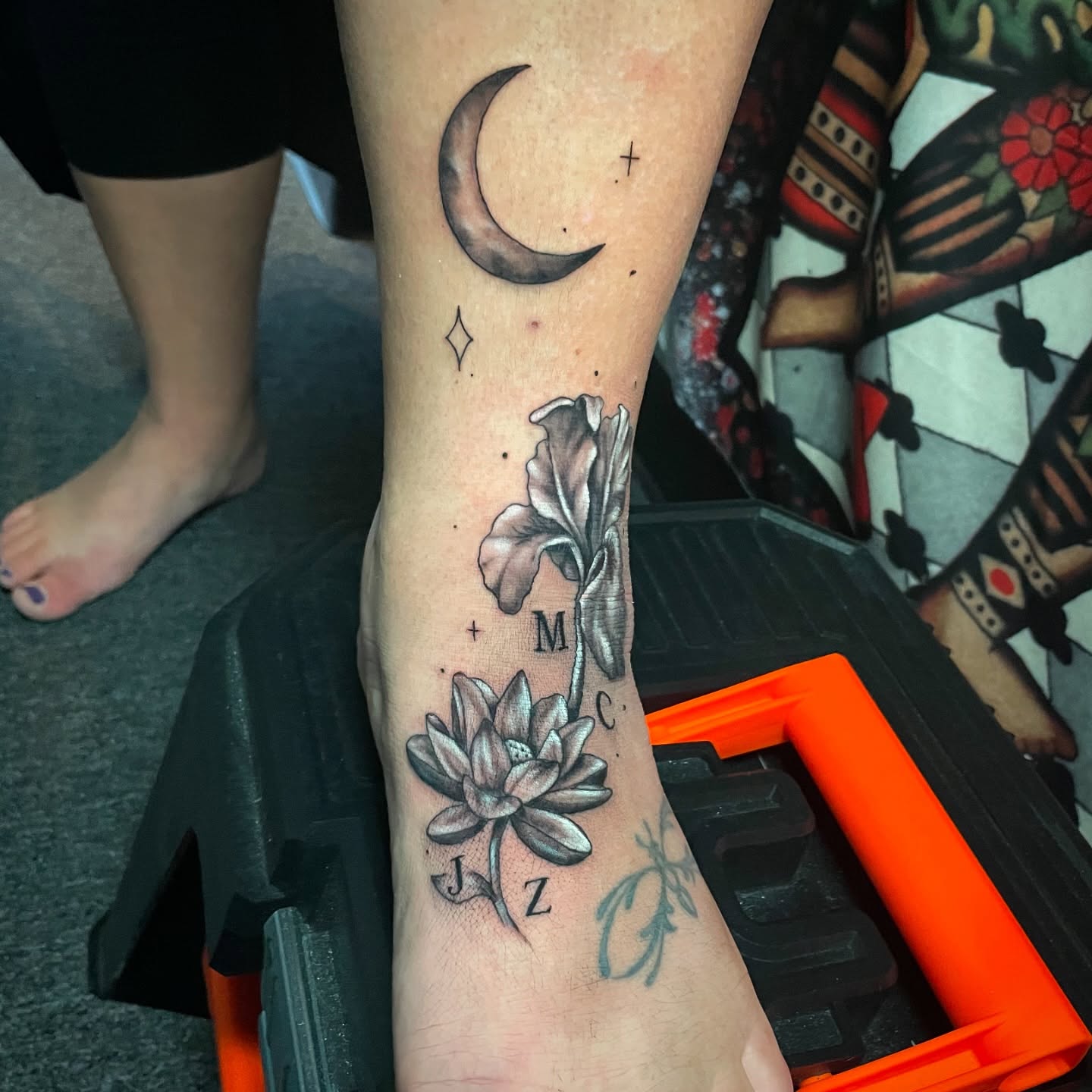 Lotus flower and moon realism tattoo on the forearm by Alexis Monkiewicz