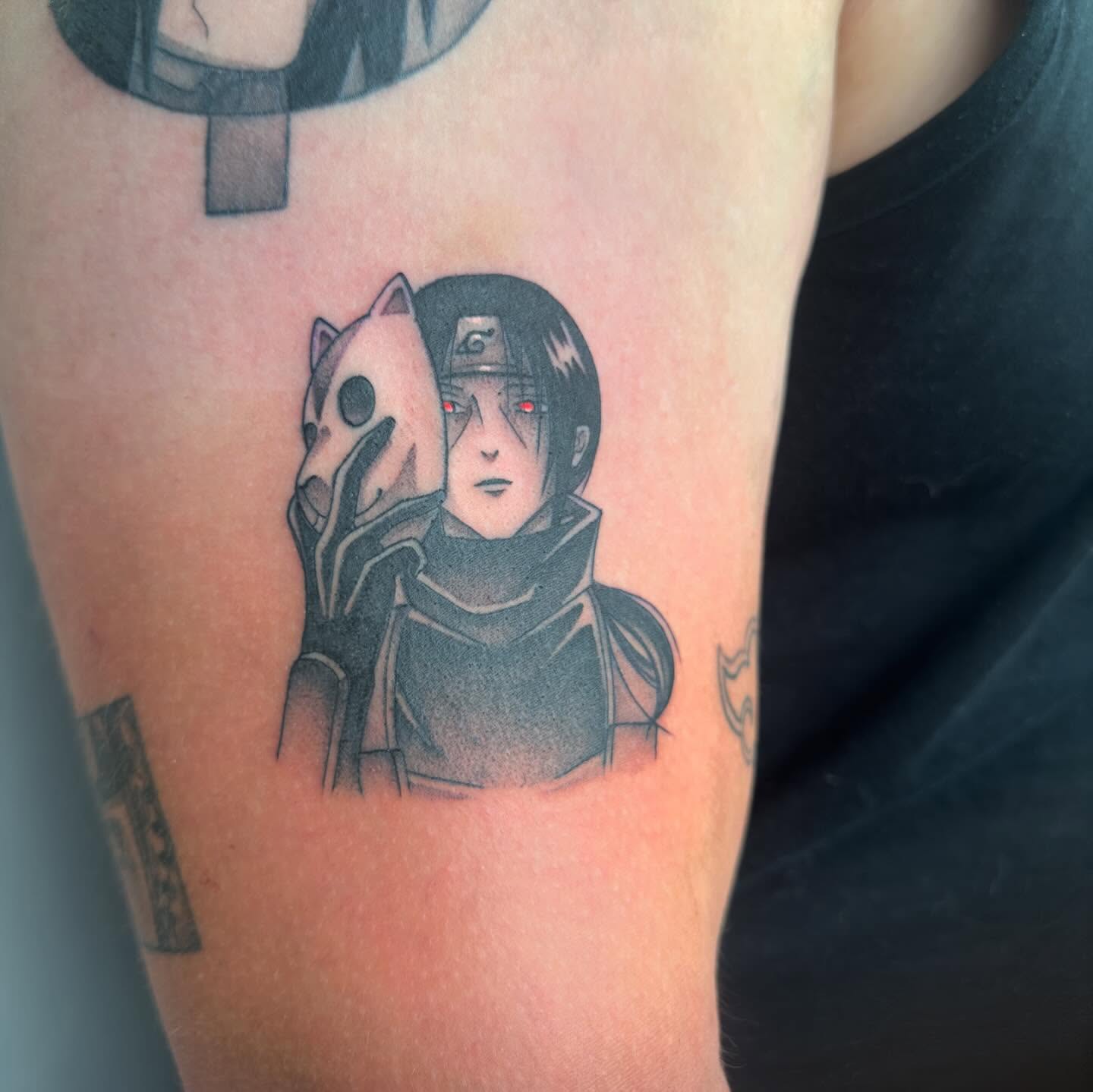 Naruto character anime tattoo on the upper arm by Alfred