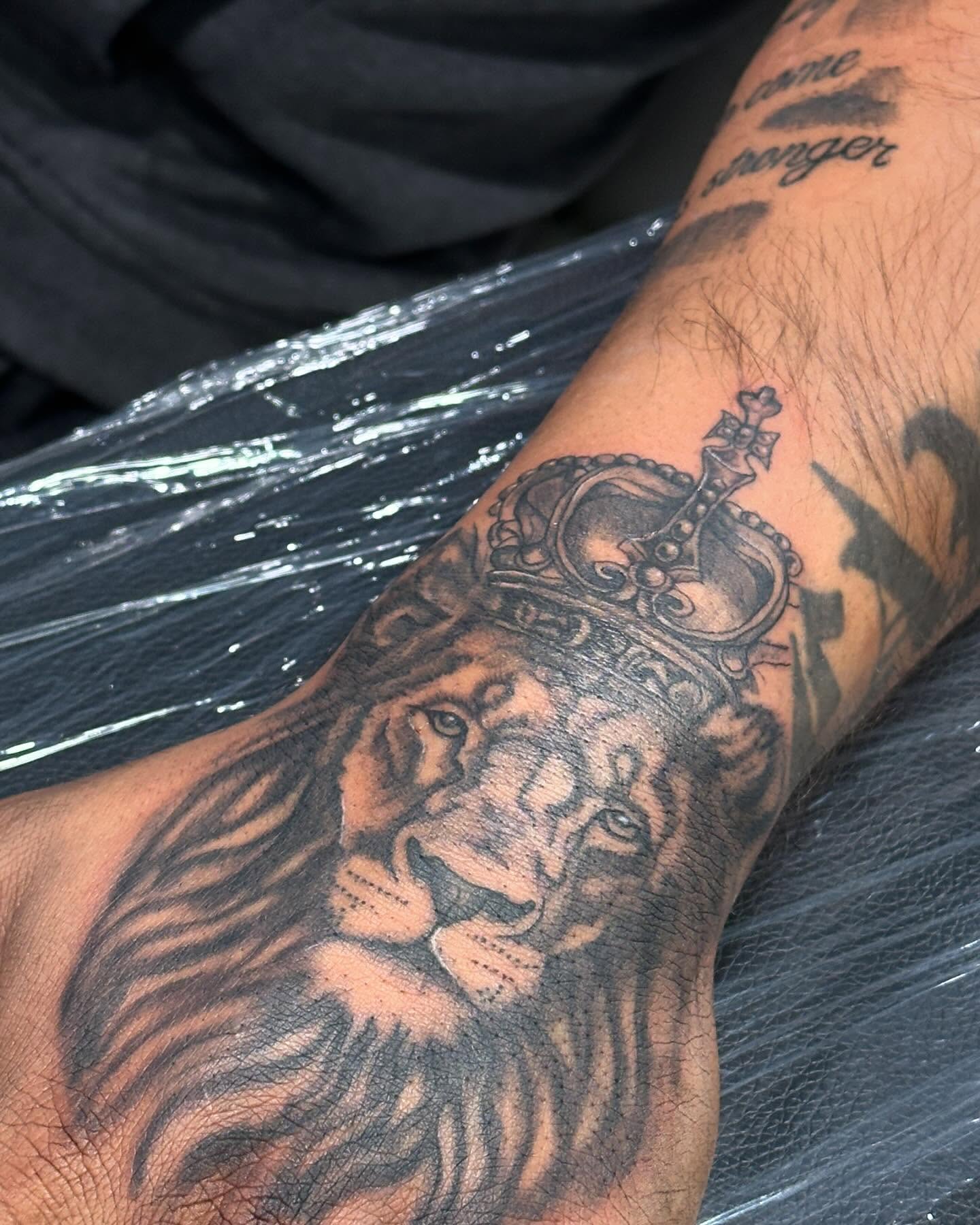 Lion with crown realism tattoo on the forearm by San Diego Tattoo Artist