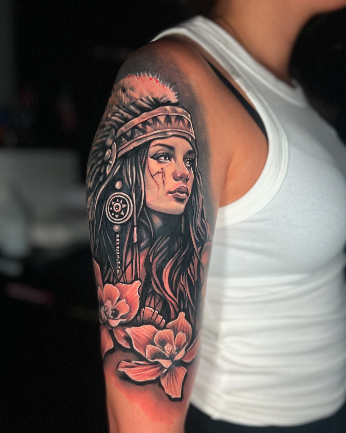 Indian woman with flowers realism tattoo on the upper arm by Yanko Reyes