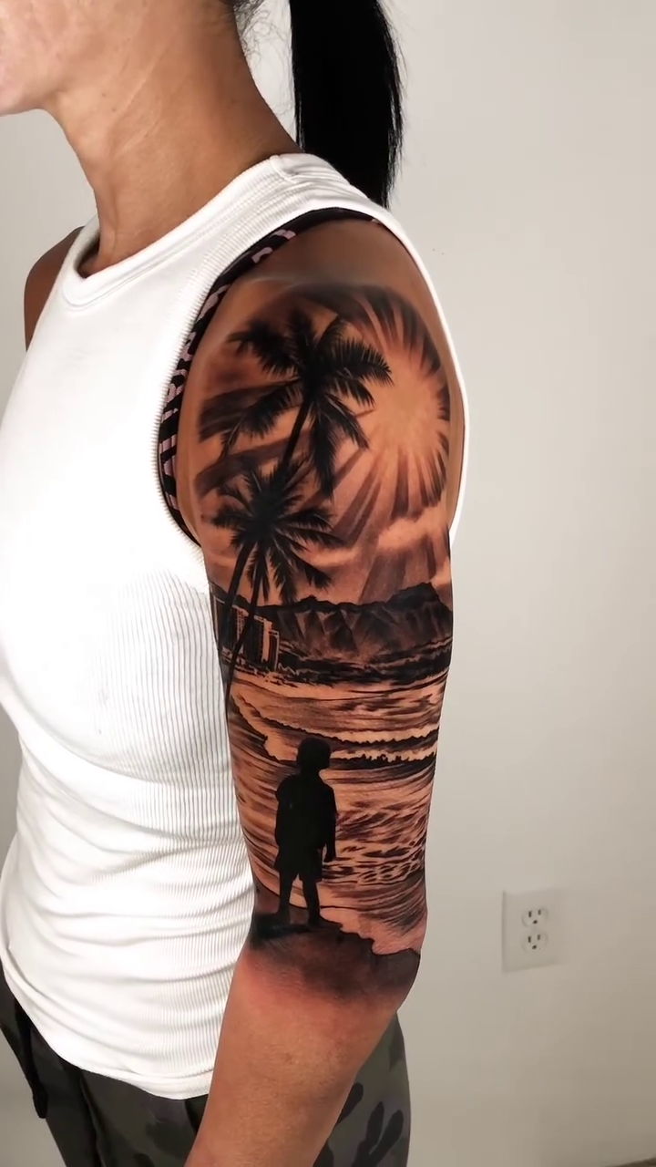 Man on a beach at sunset realism tattoo by David "Mager" Torres