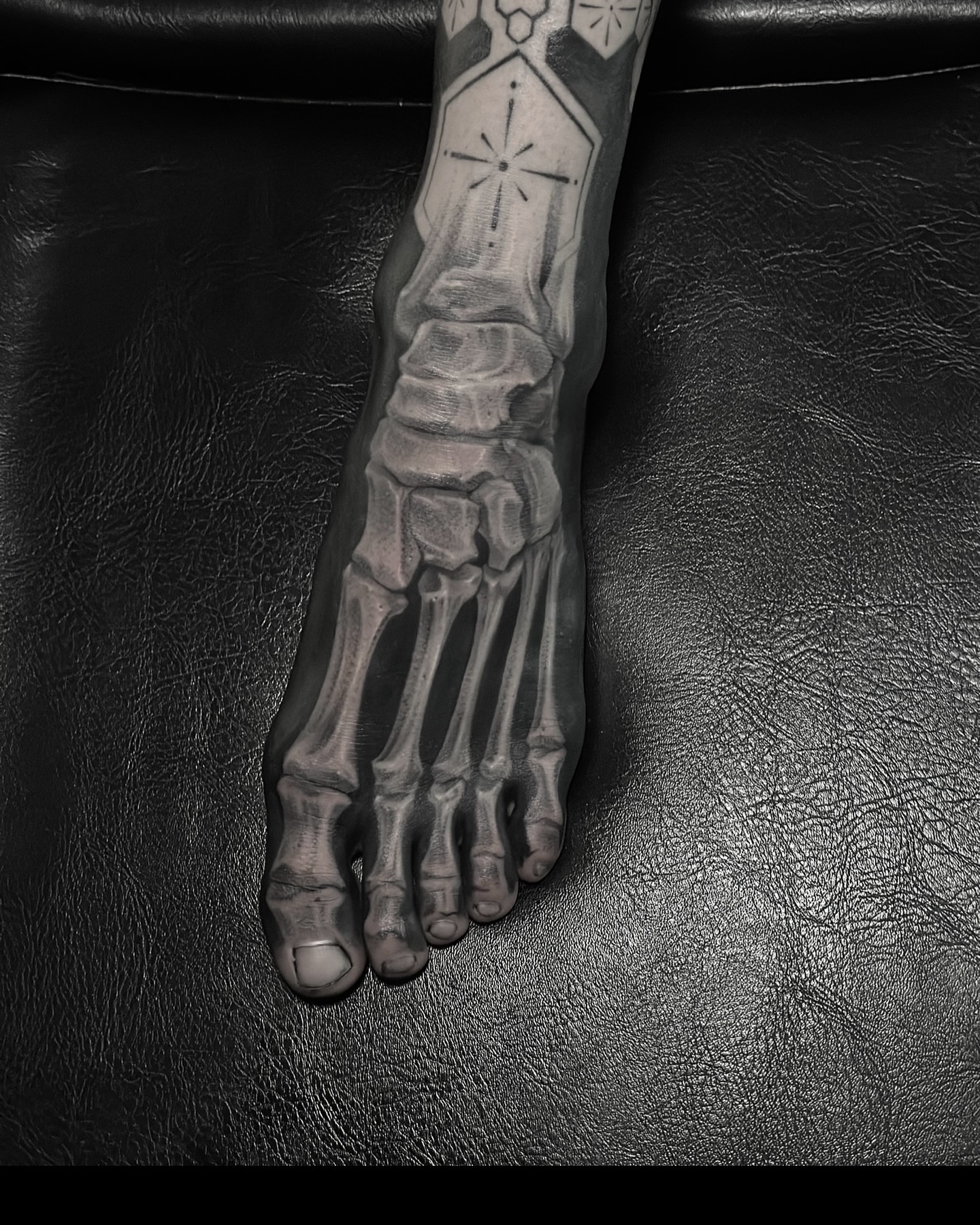 Skeleton geometric tattoo on the foot by Z.