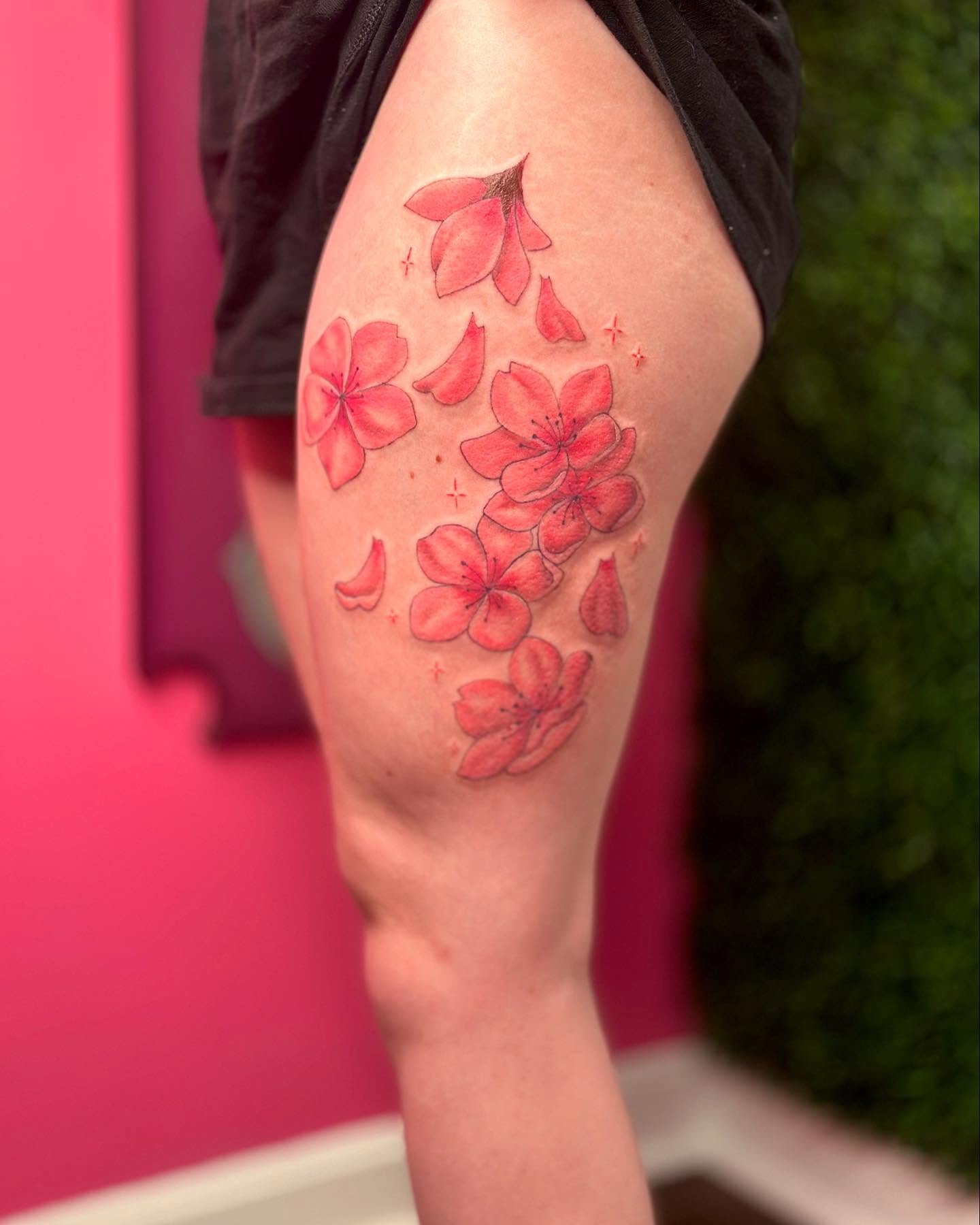 Cherry blossoms realism tattoo on the thigh by Jakki Hicks