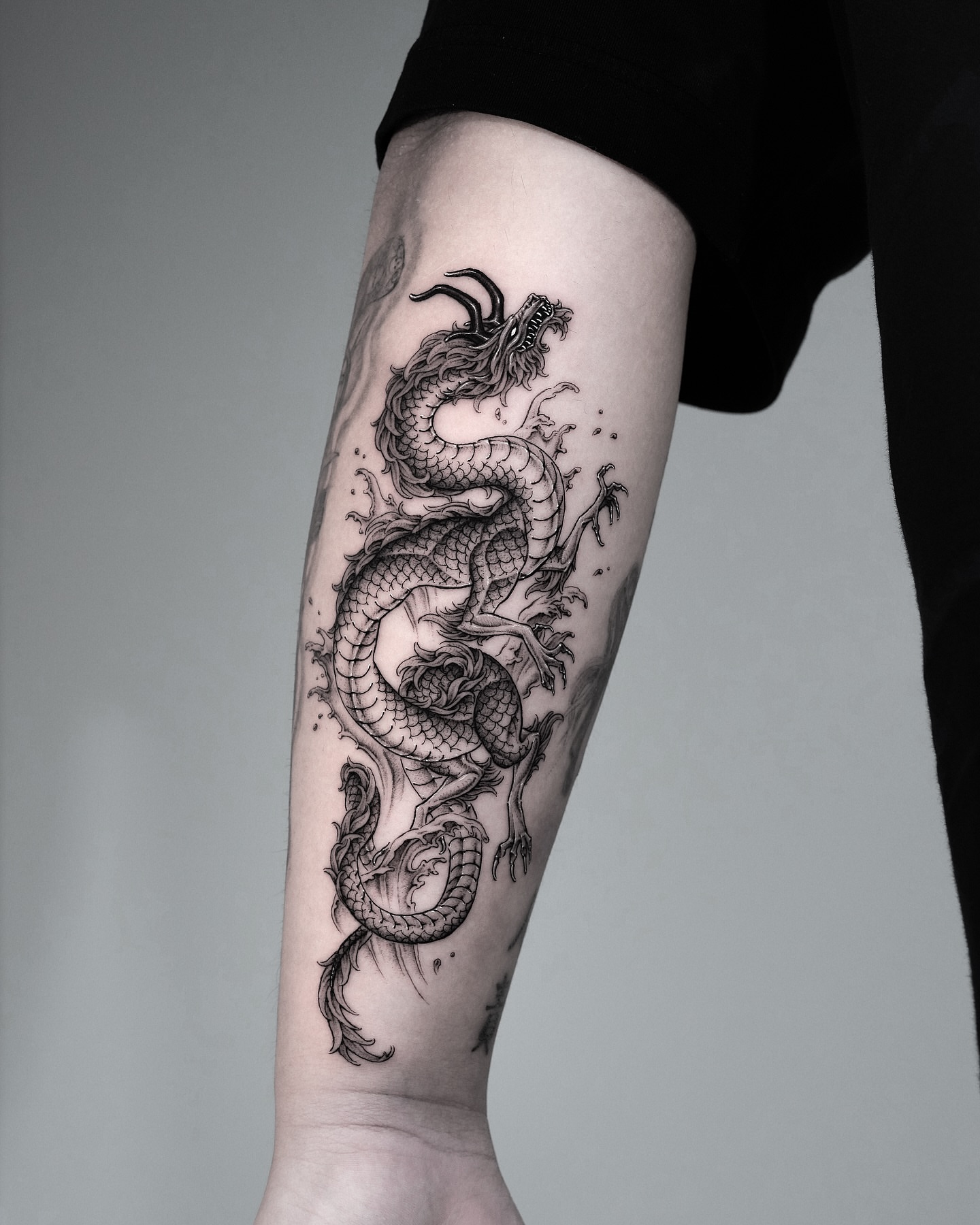 Dragon realism tattoo on the forearm by Intat