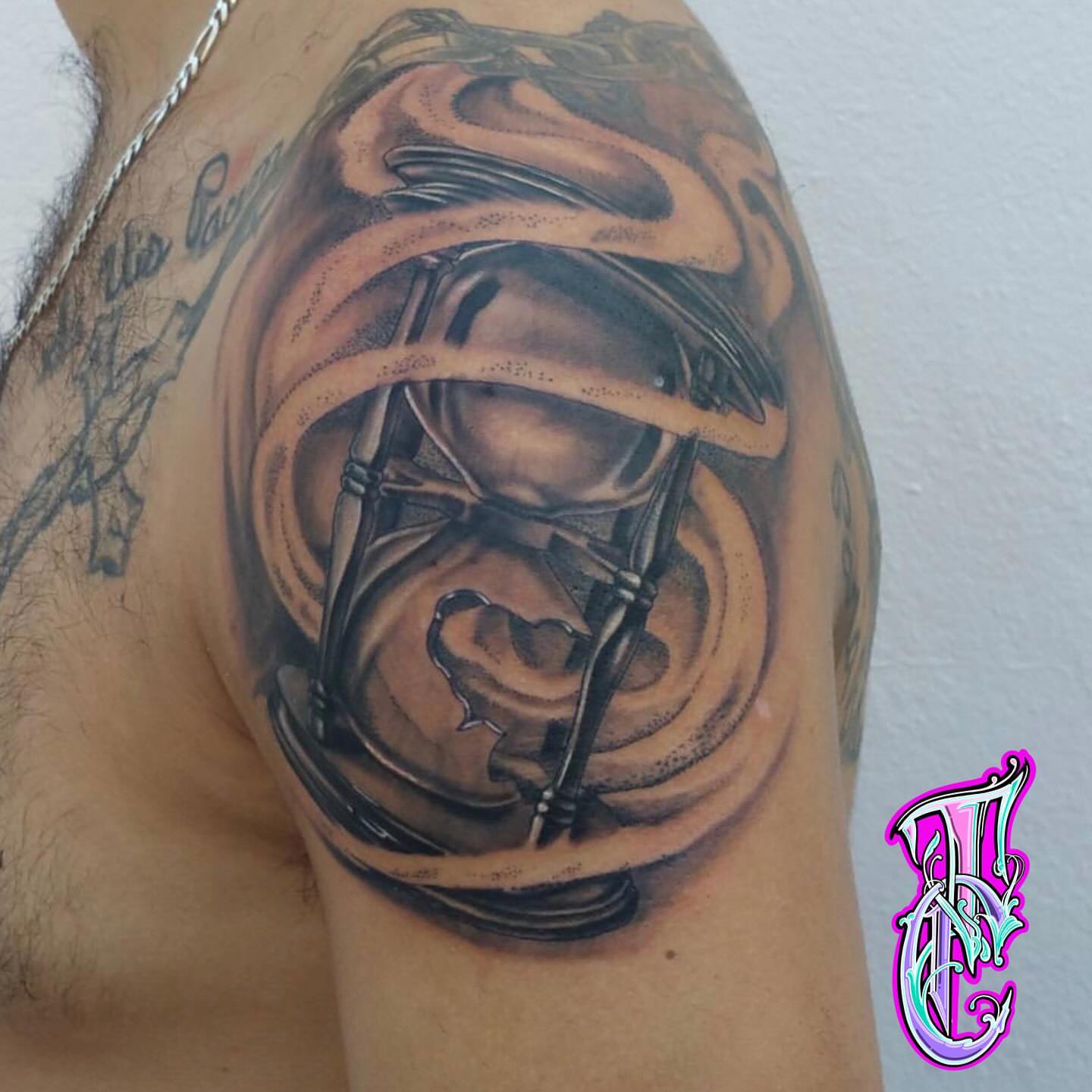 Hourglass realism tattoo on the shoulder by Thea Curlee